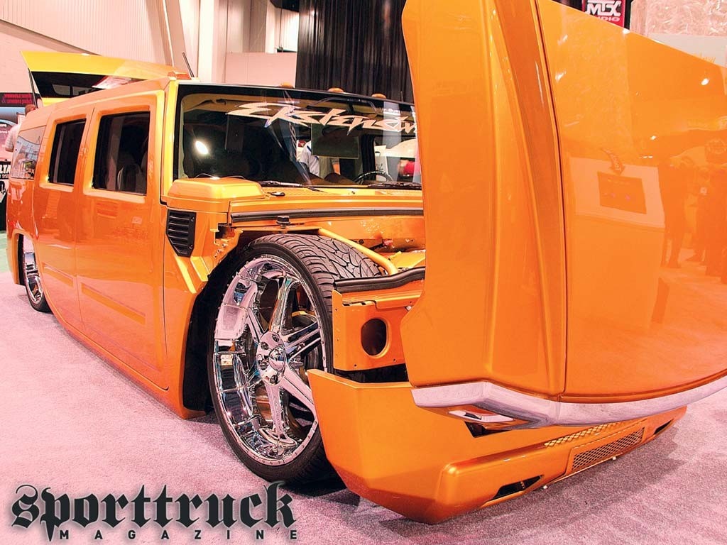 Orange Hummer H2 with custom wheels at Sporttruck Magazine HD Wallpaper