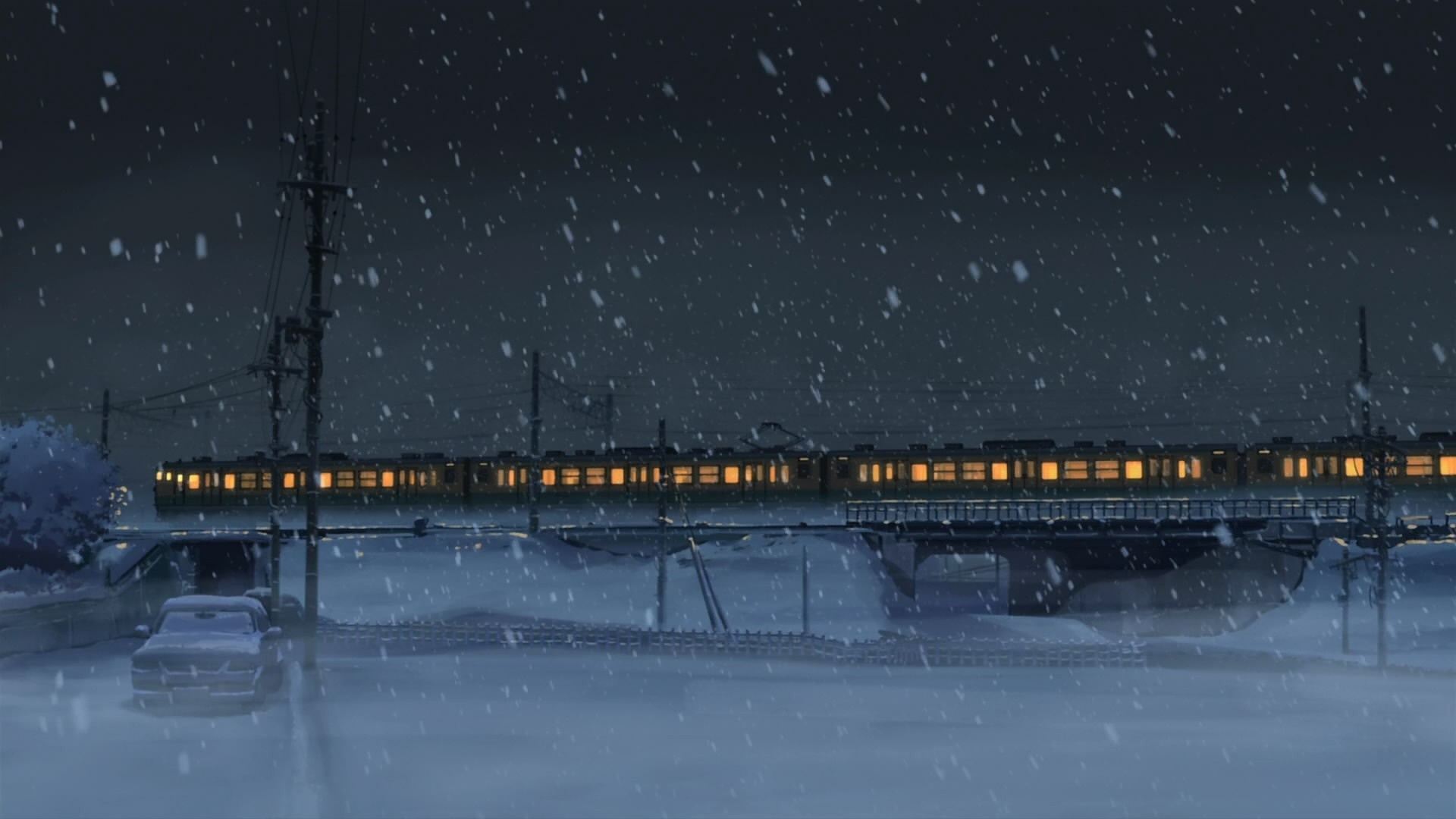 Train crossing a bridge in the snow at night HD Wallpaper