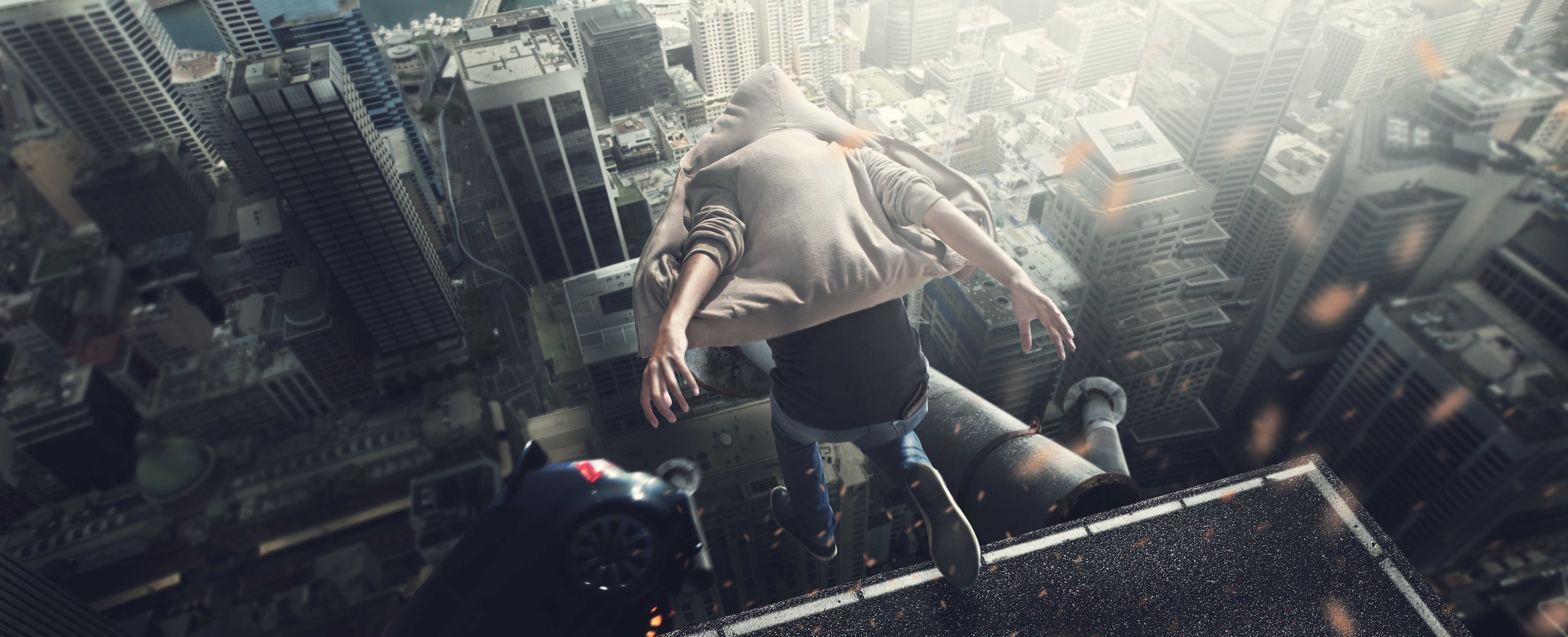 Person in hoodie jumping off a skyscraper HD Wallpaper