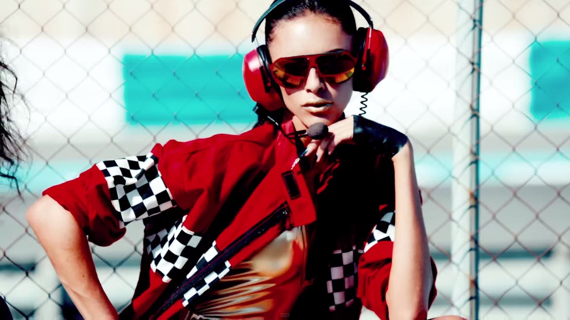Woman in red racing jacket and headphones HD Wallpaper