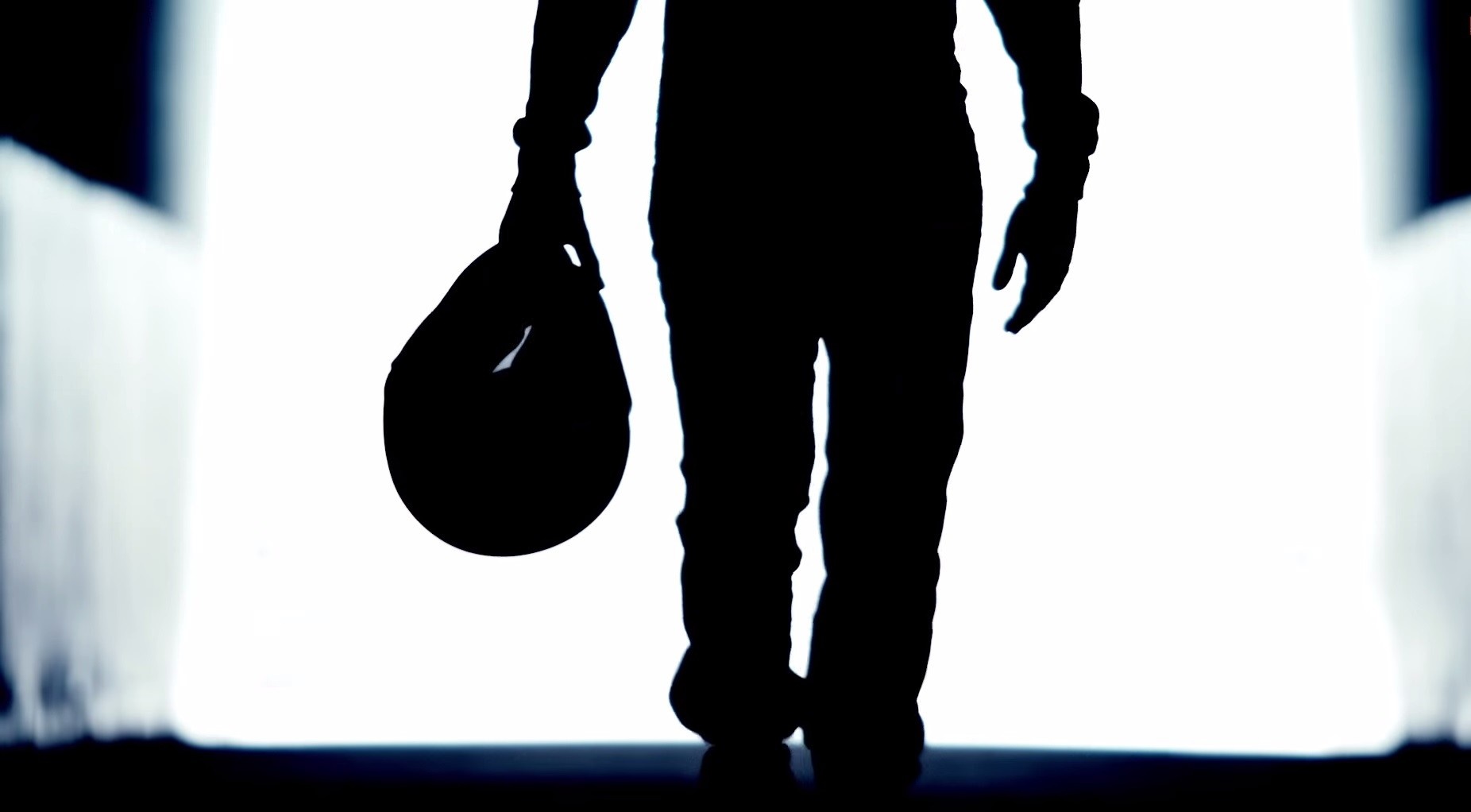 Silhouette of a person holding a helmet HD Wallpaper