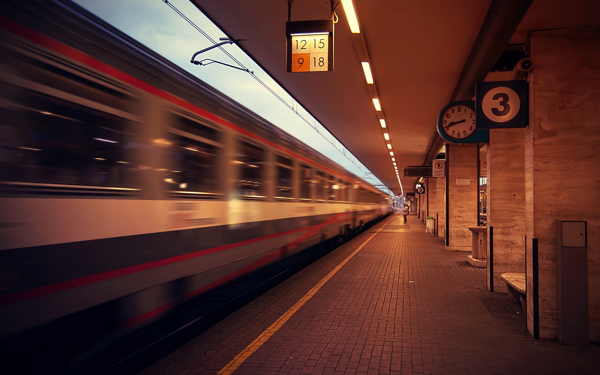 Train arriving at a station at dusk HD Wallpaper