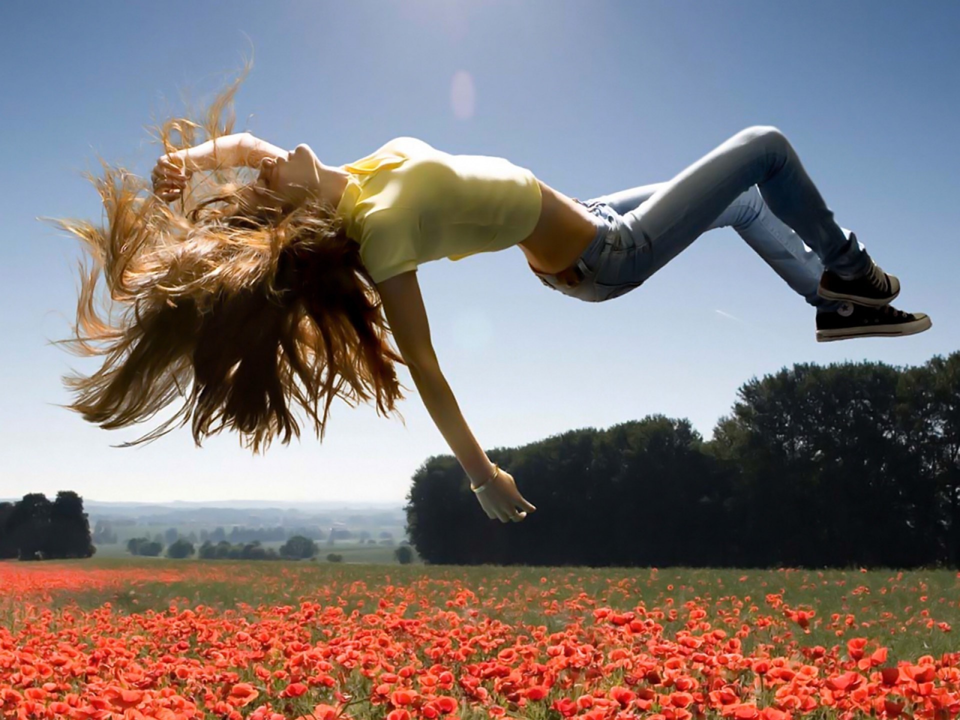 Woman floating in a poppy field HD Wallpaper