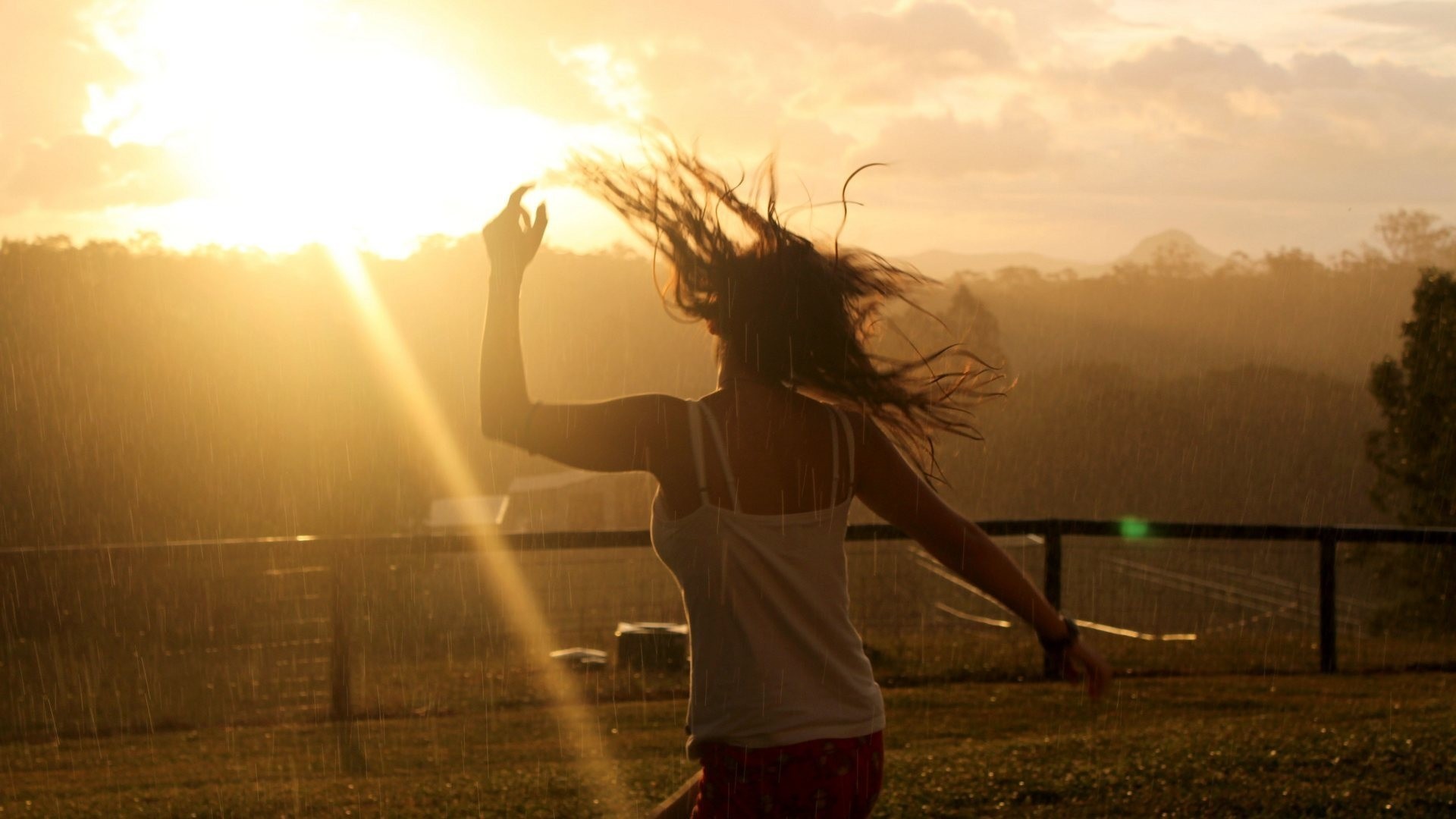 Woman dancing in the rain at sunset HD Wallpaper