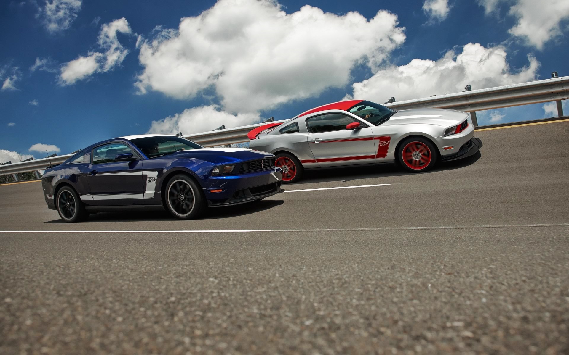 Two Ford Mustang Boss 302 cars on a road HD Wallpaper