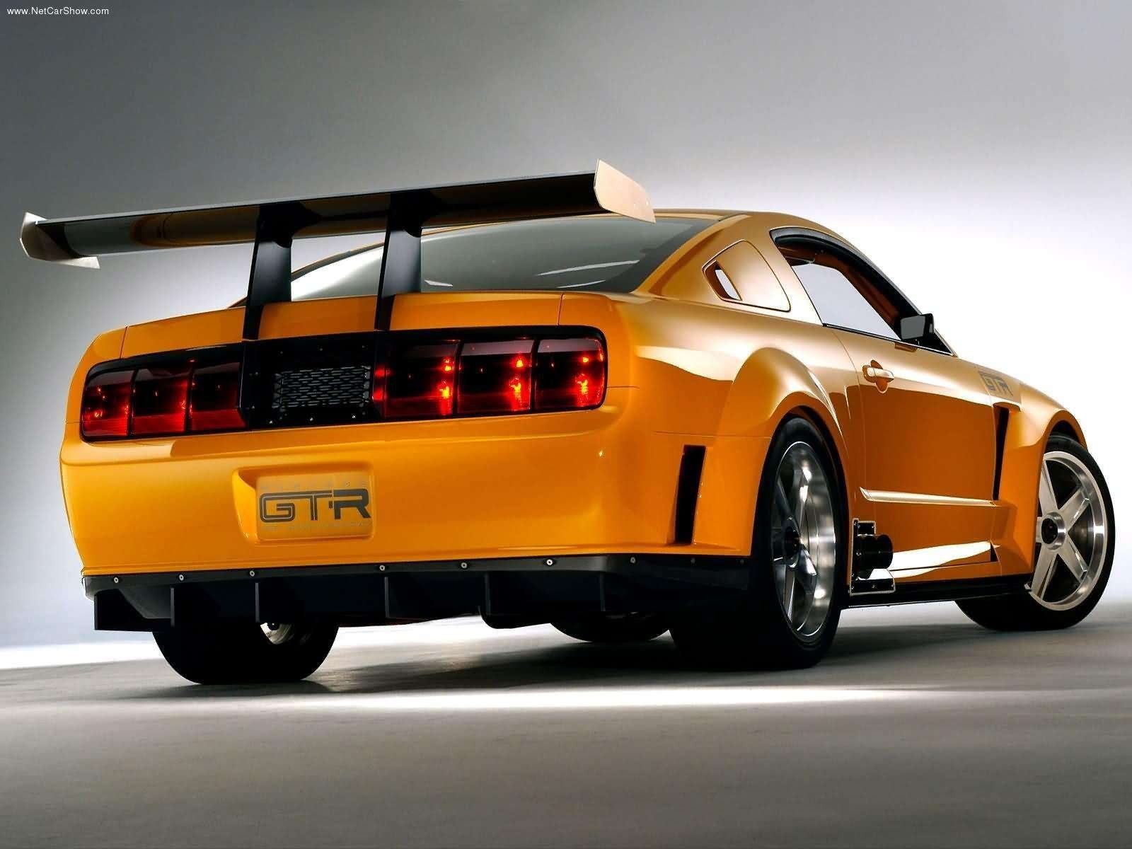 Orange Ford Mustang GTR with a large rear spoiler HD Wallpaper