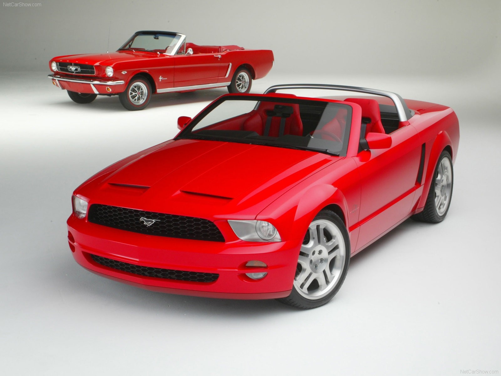 Two red Ford Mustang convertibles, classic and modern HD Wallpaper