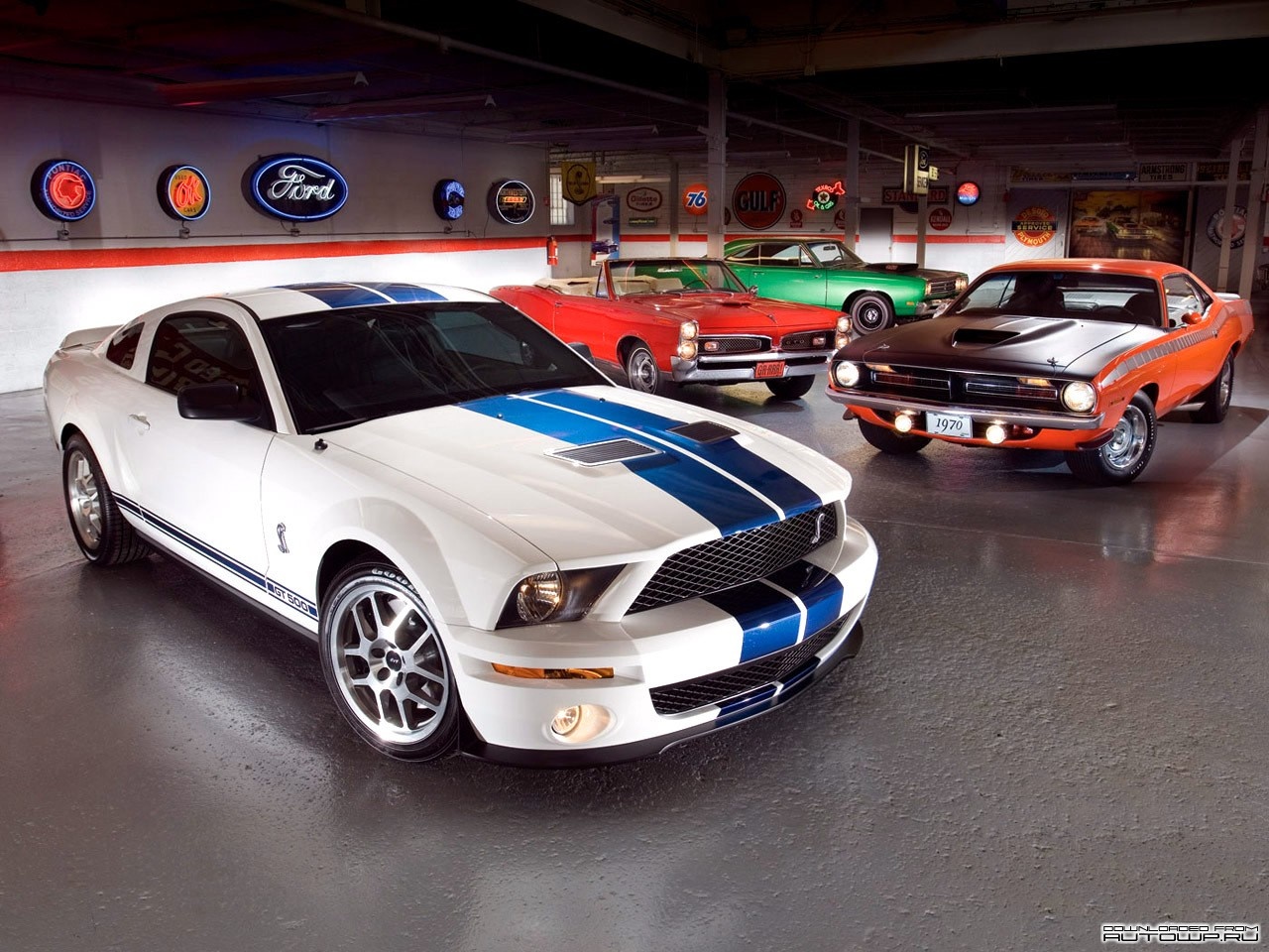 Ford Mustang Shelby GT500, Plymouth Barracuda, and other classic cars in a garage HD Wallpaper