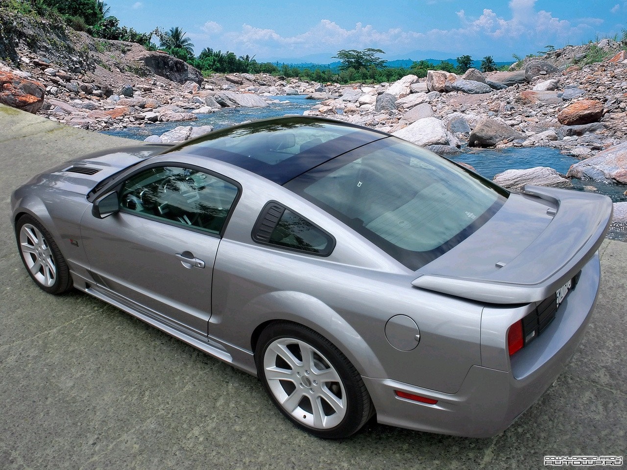 Silver Ford Shelby Mustang with a sunroof parked by a rocky river HD Wallpaper