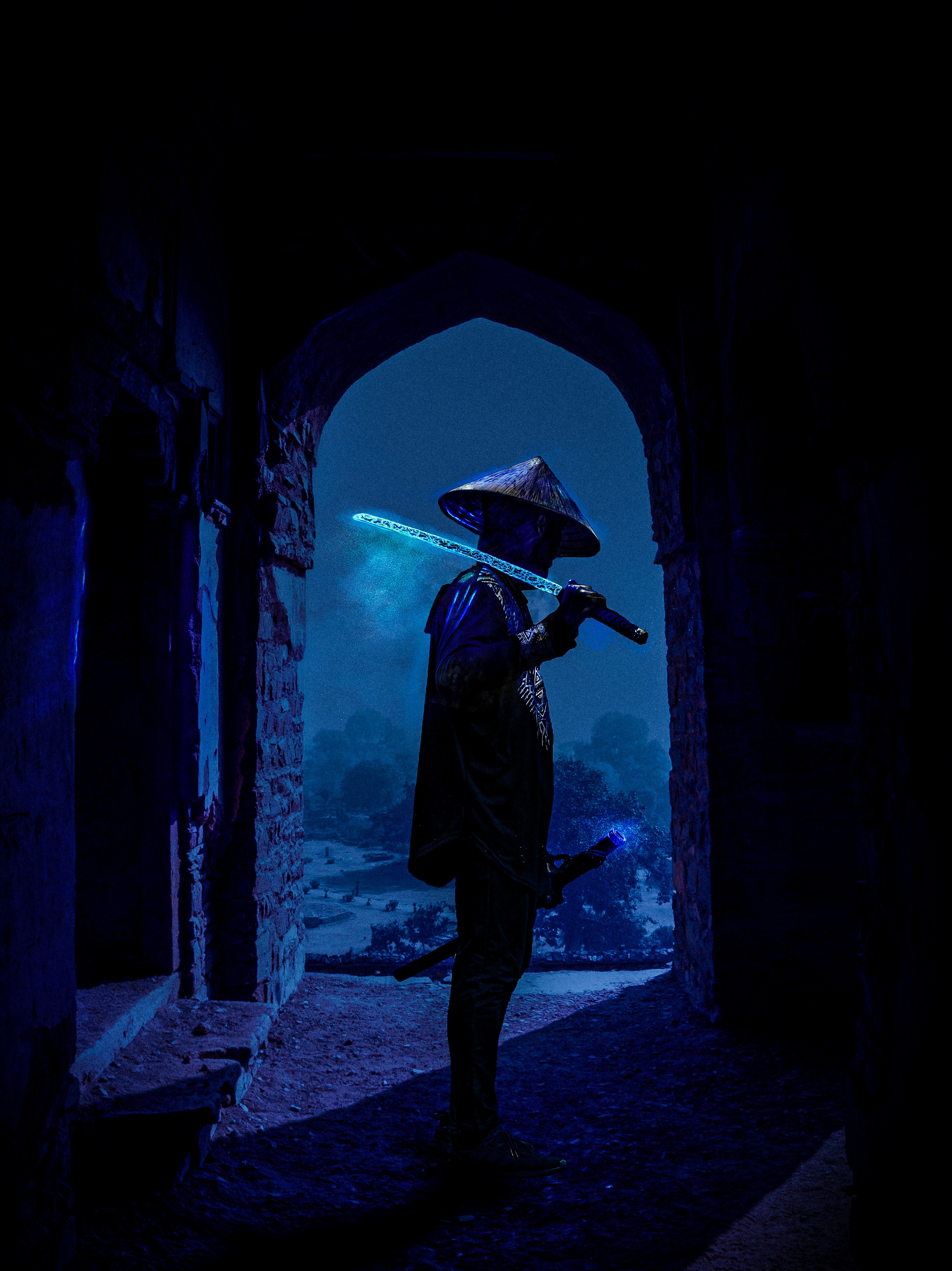 Samurai with glowing sword in ancient ruins at night HD Phone Wallpaper