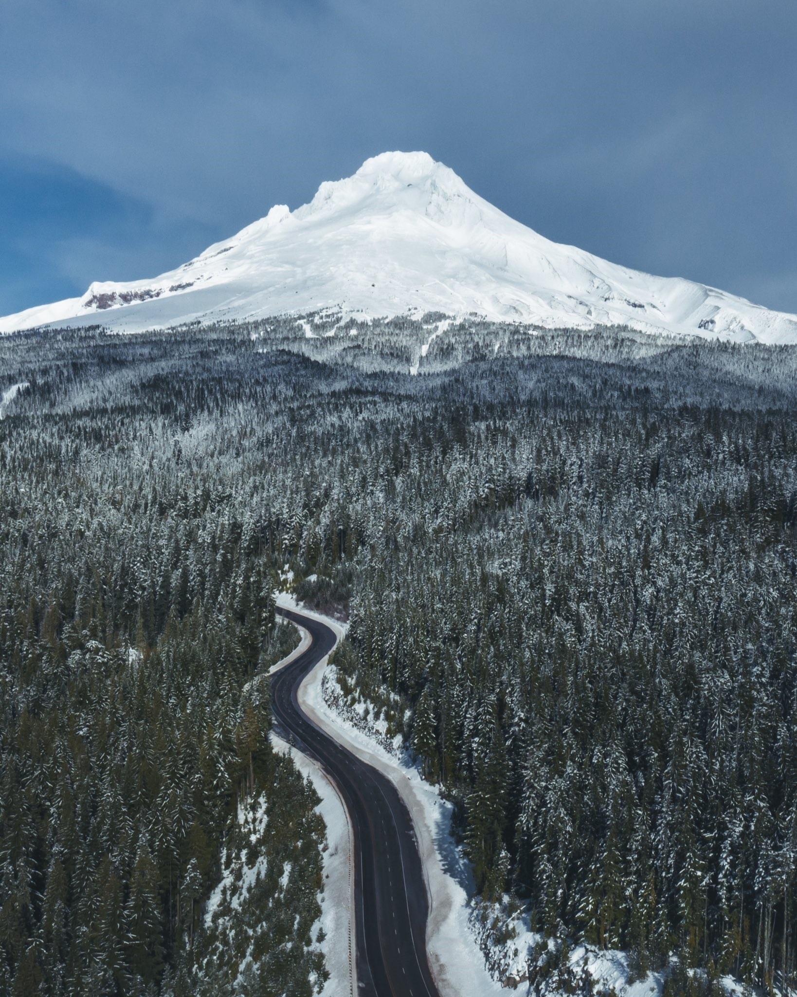 Snowy Mountain and Winding Road Through Forest HD Phone Wallpaper