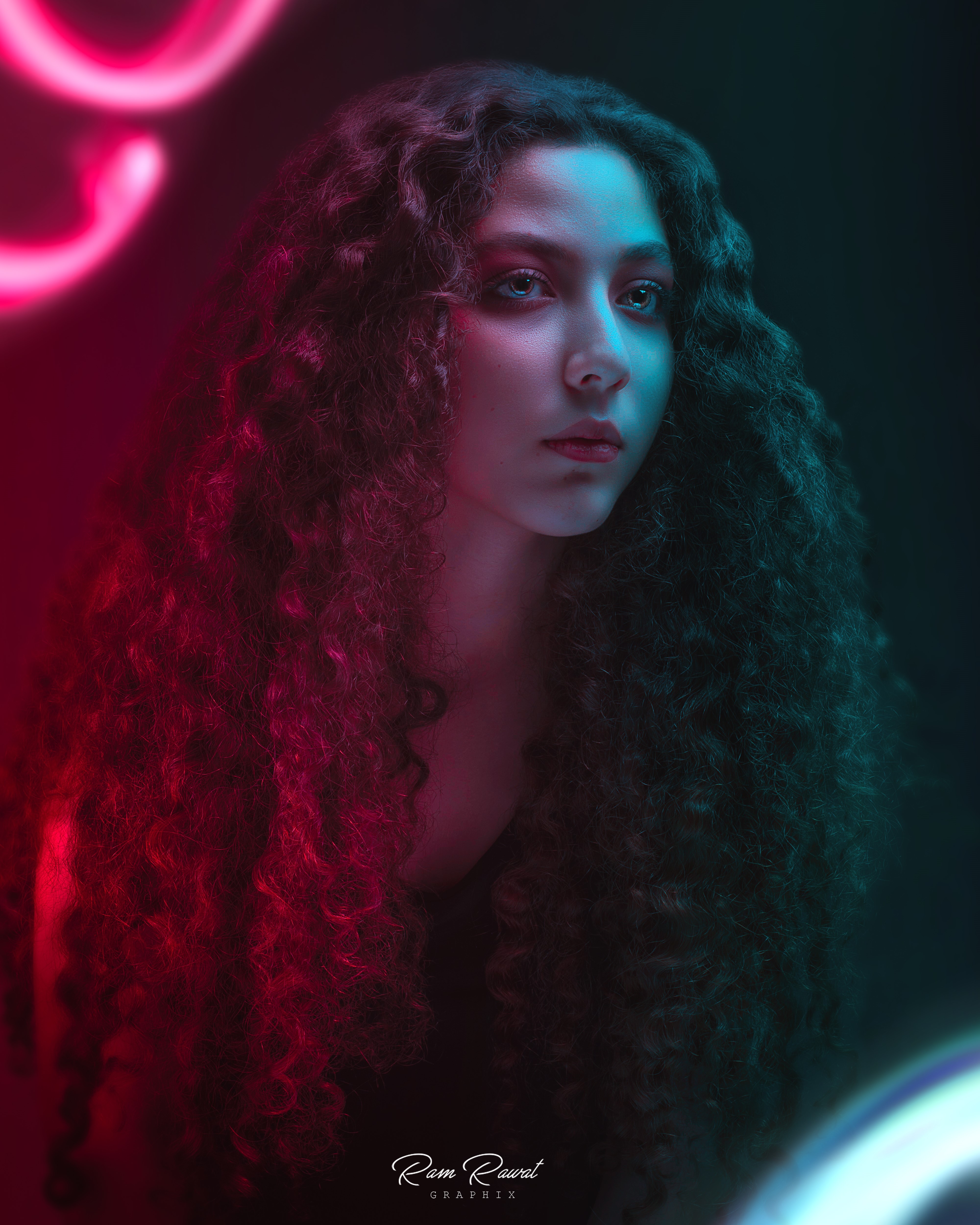 Woman with curly hair illuminated by neon lights HD Phone Wallpaper