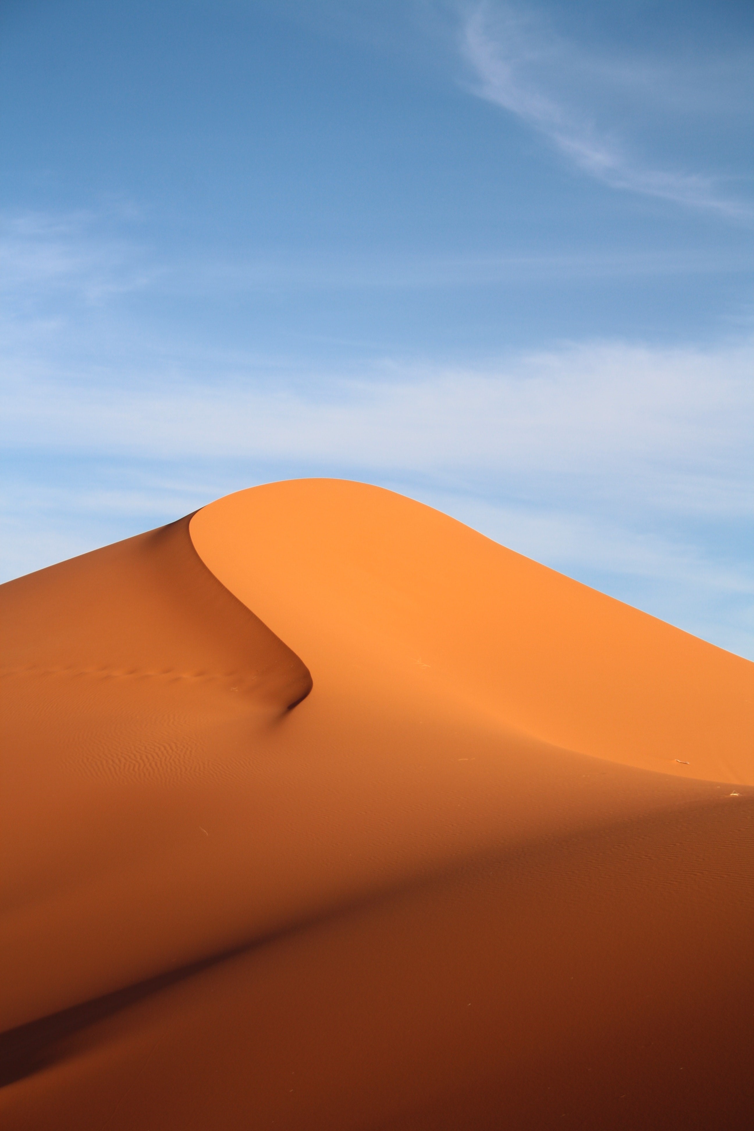 Desert sand dunes under a blue sky HD Phone Wallpaper