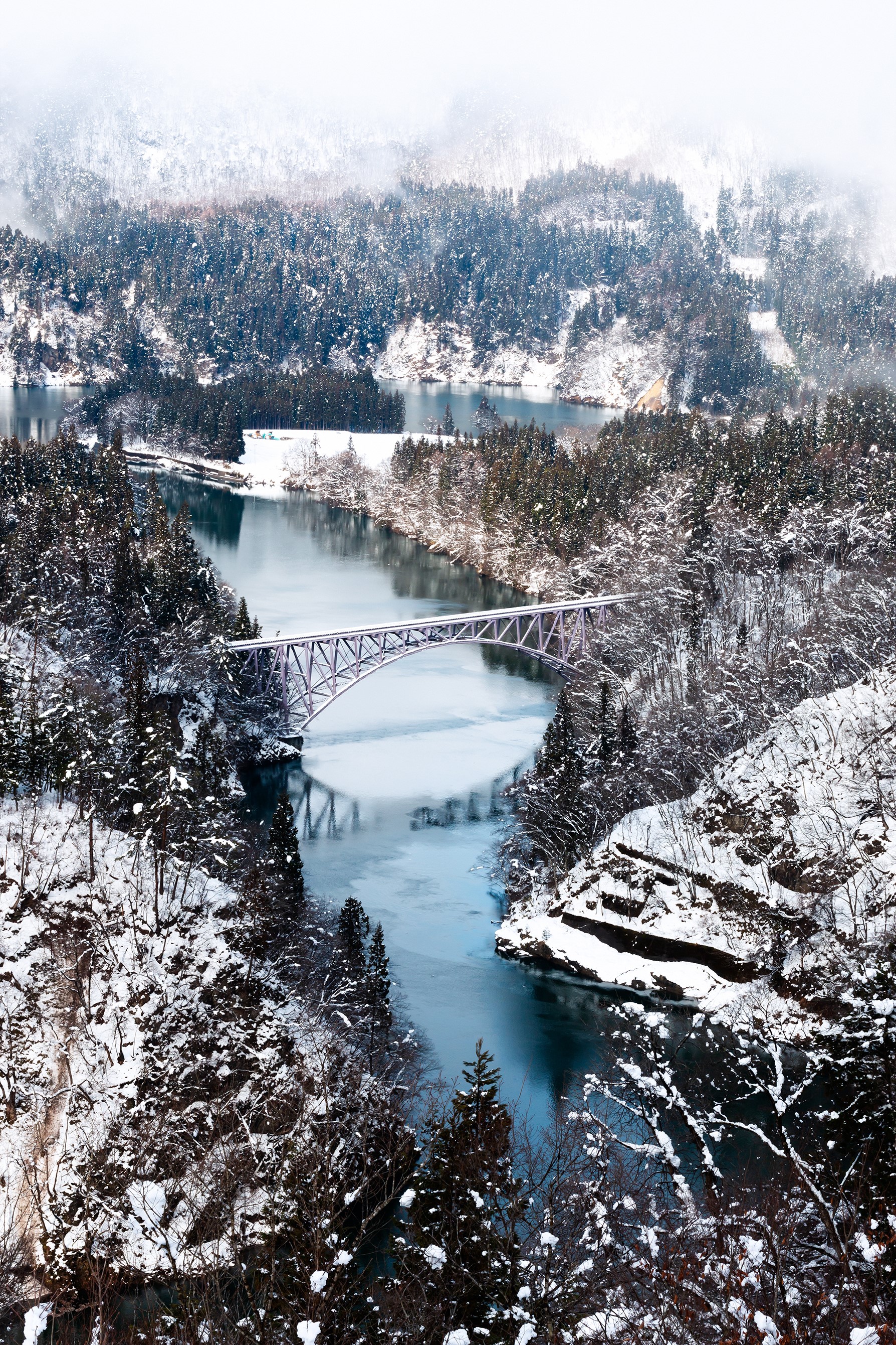 Snowy valley with a bridge over a river in Japan HD Phone Wallpaper