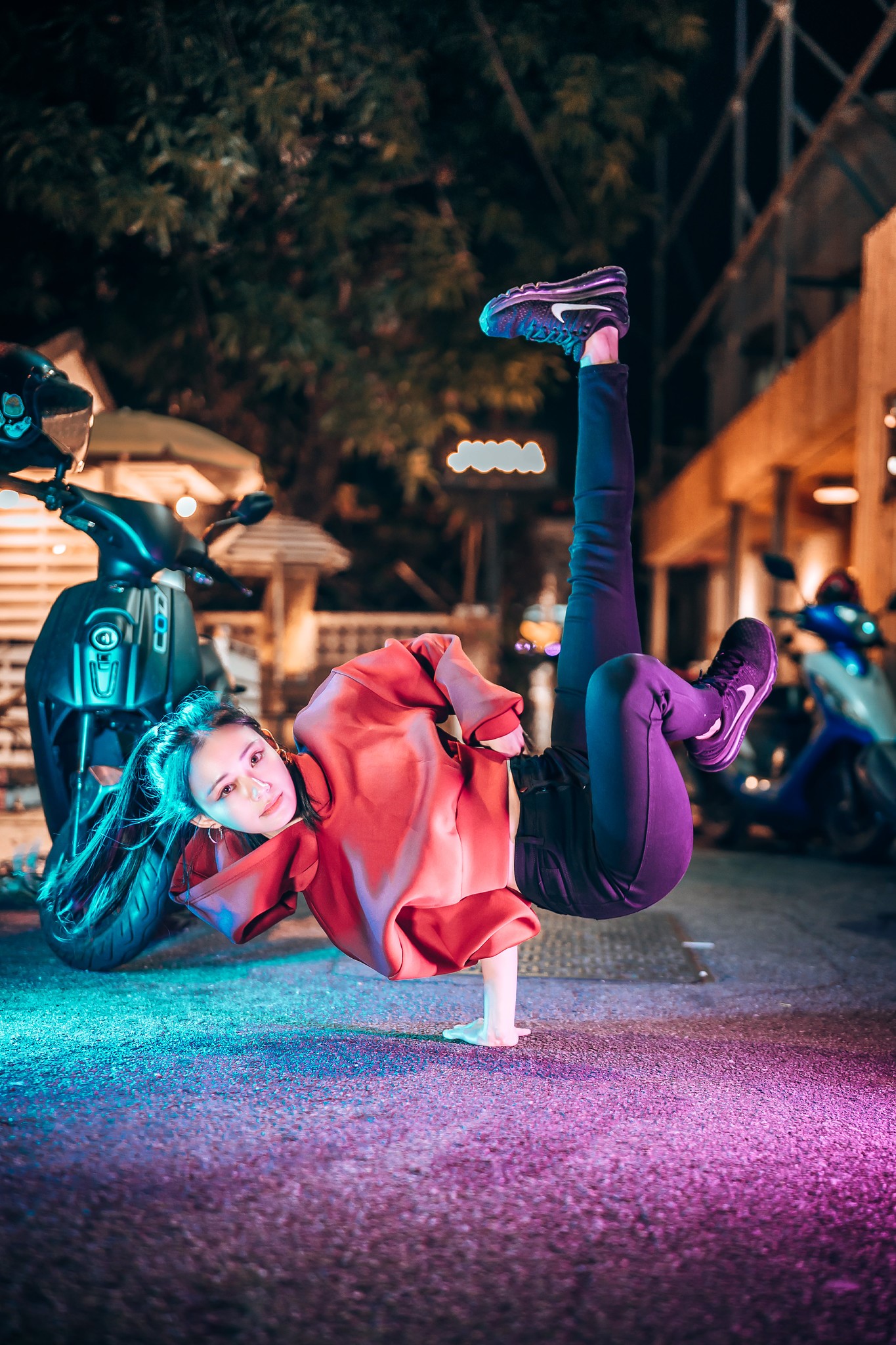 Woman breakdancing on a street at night HD Phone Wallpaper