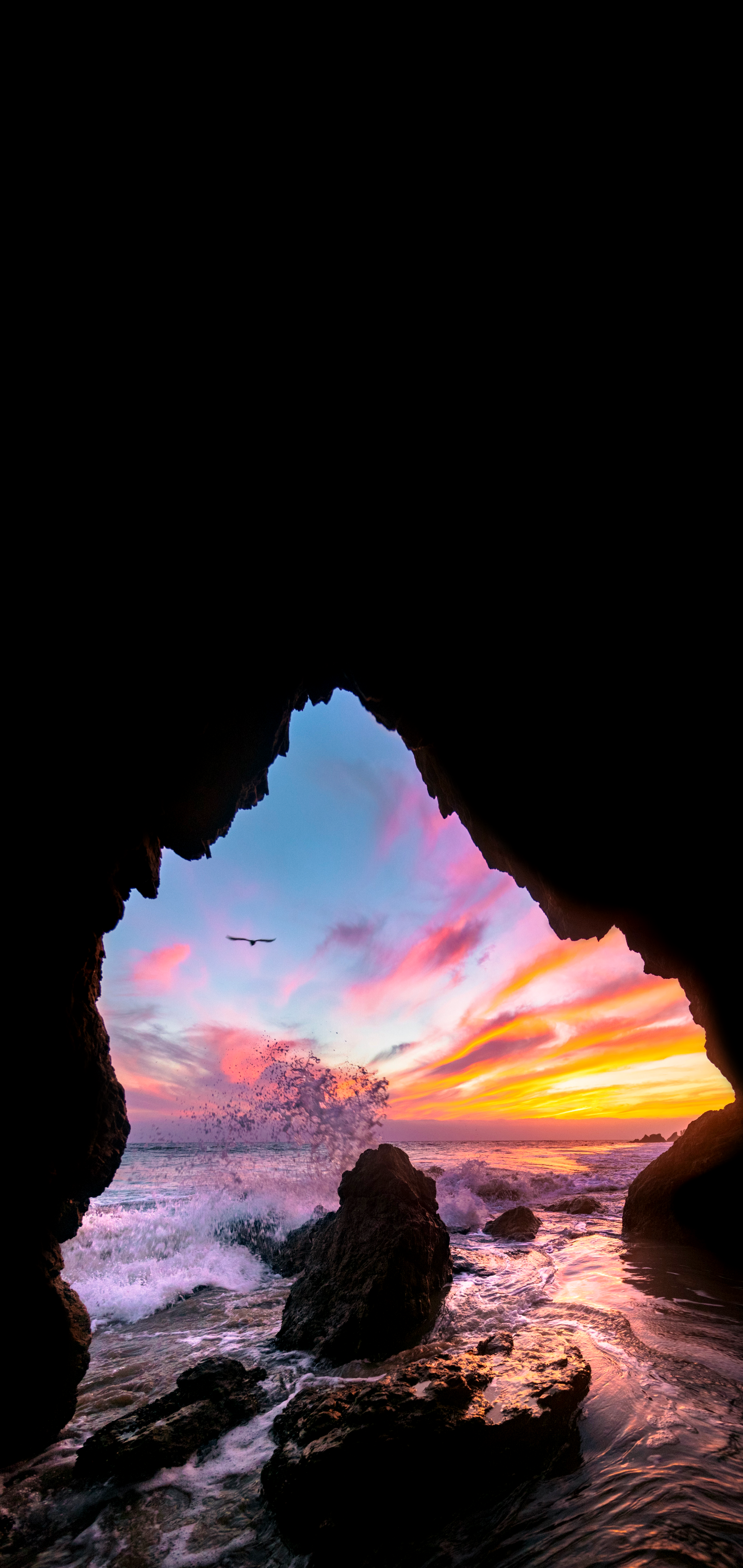 Cave entrance overlooking ocean sunset with bird HD Phone Wallpaper