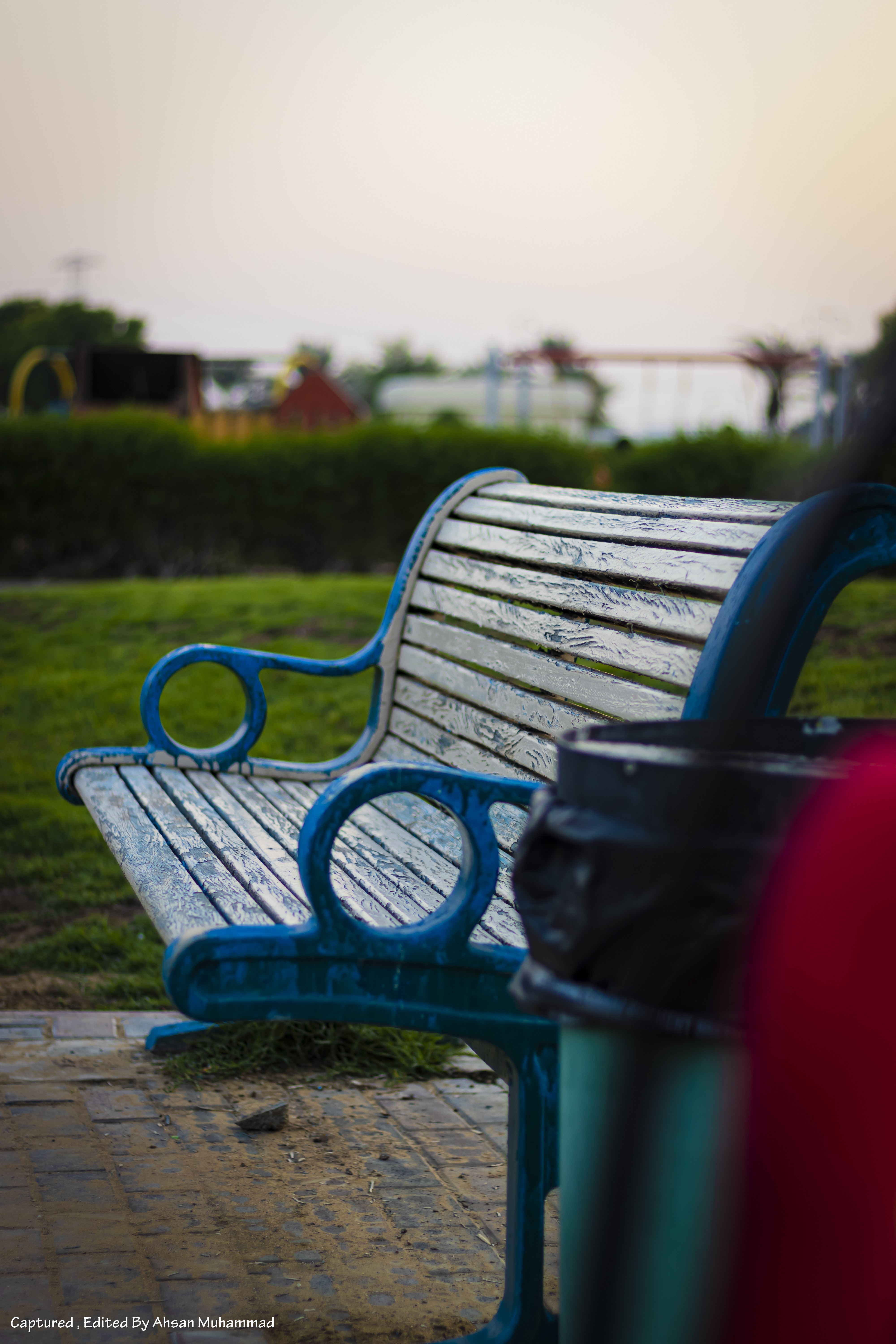 Park bench with playground in the background at sunset HD Phone Wallpaper