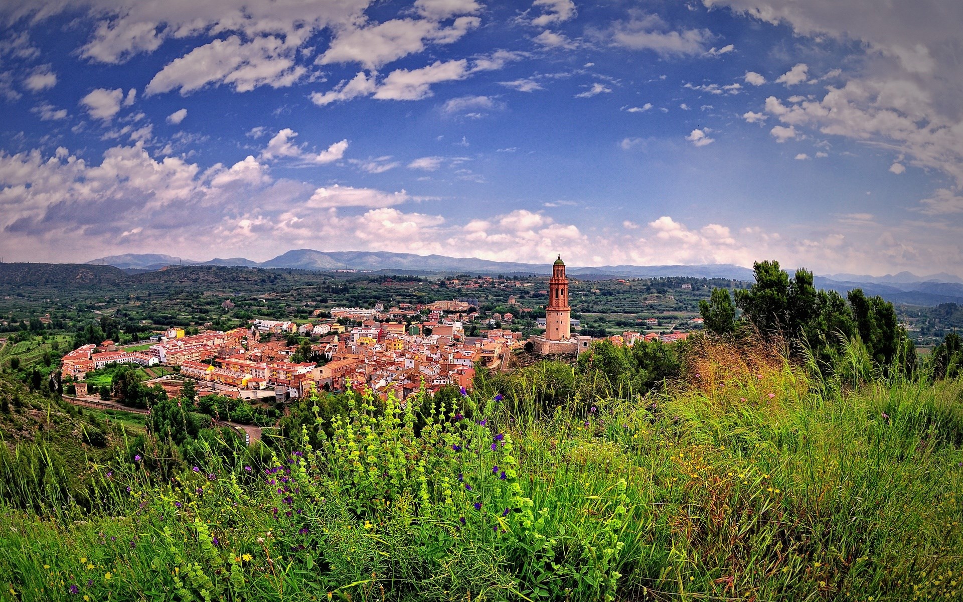 Panoramic view of a Spanish town with a bell tower HD Wallpaper