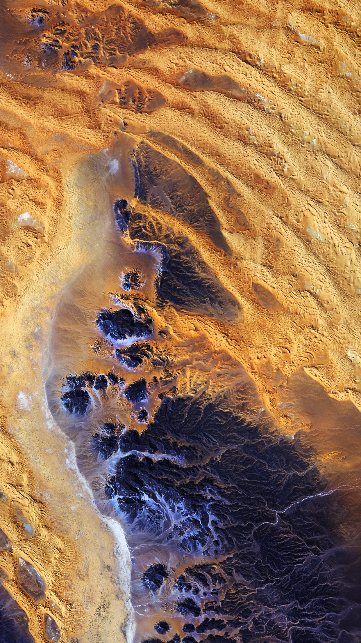 Satellite view of desert landscape with sand dunes and eroded mountains HD Phone Wallpaper