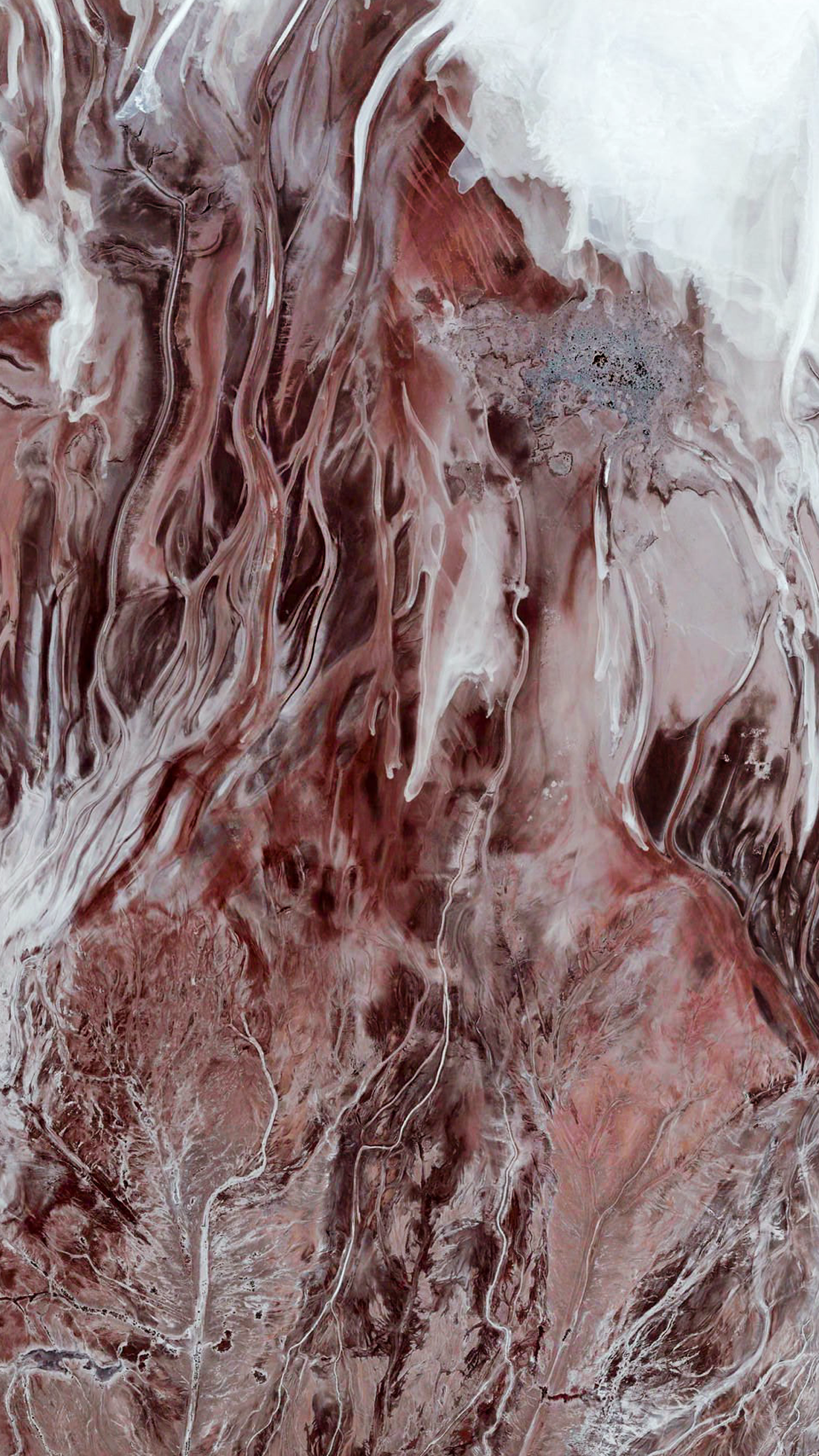 Aerial view of a dry riverbed with mineral deposits HD Phone Wallpaper