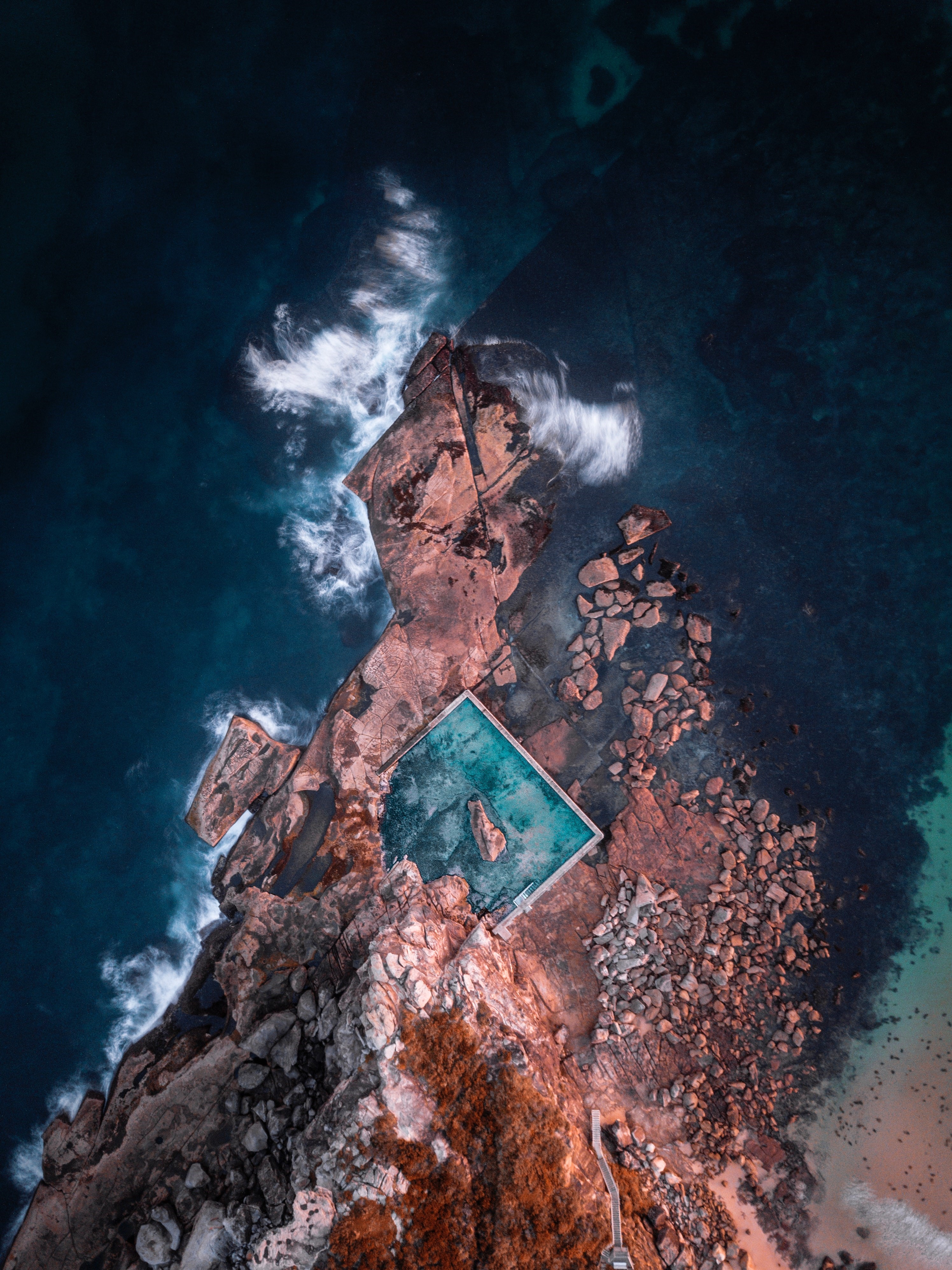 Aerial view of a rock pool on a rocky coastline HD Phone Wallpaper