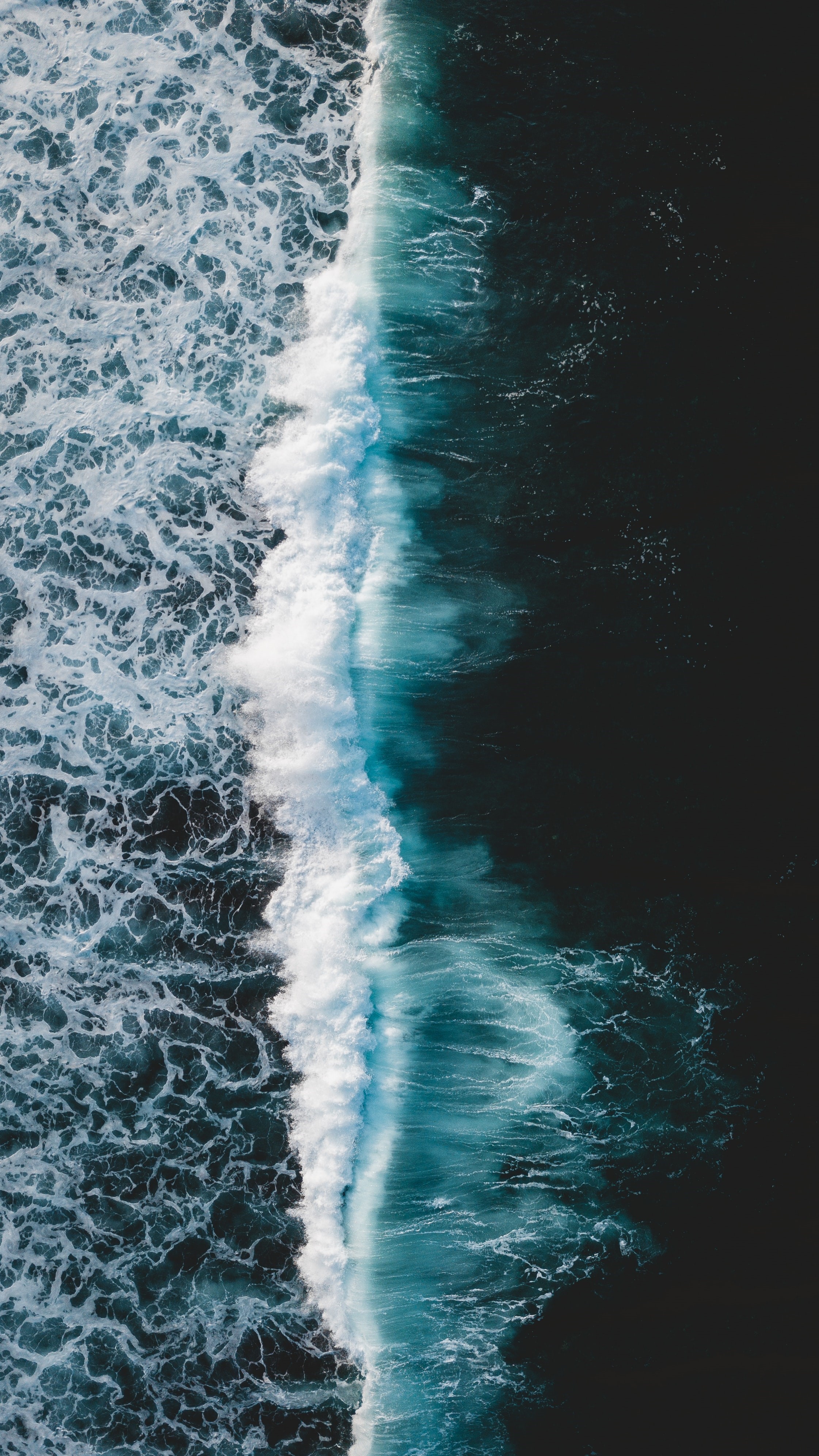 Aerial view of a breaking ocean wave HD Phone Wallpaper