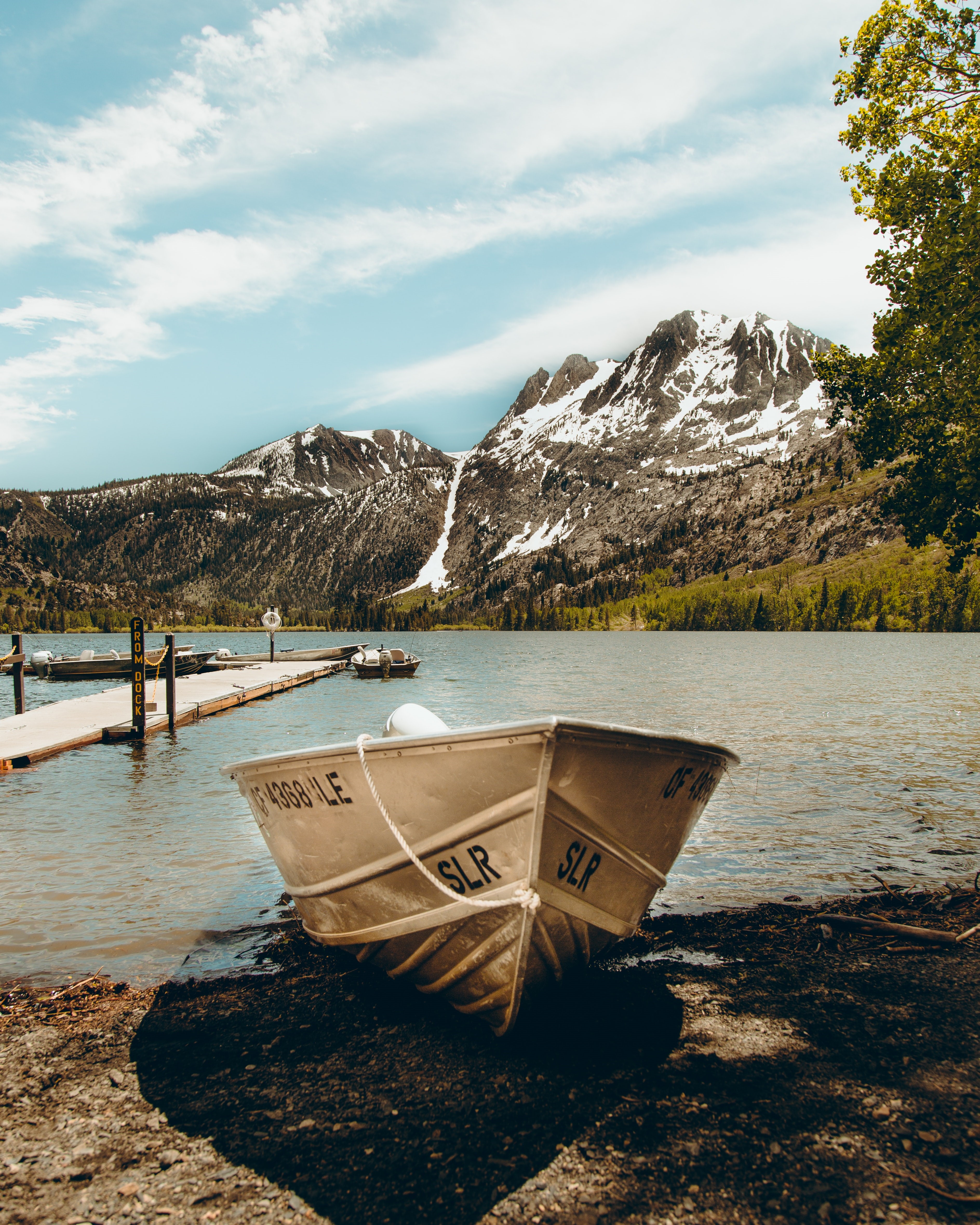 Boat on a lake with snowy mountains HD Phone Wallpaper