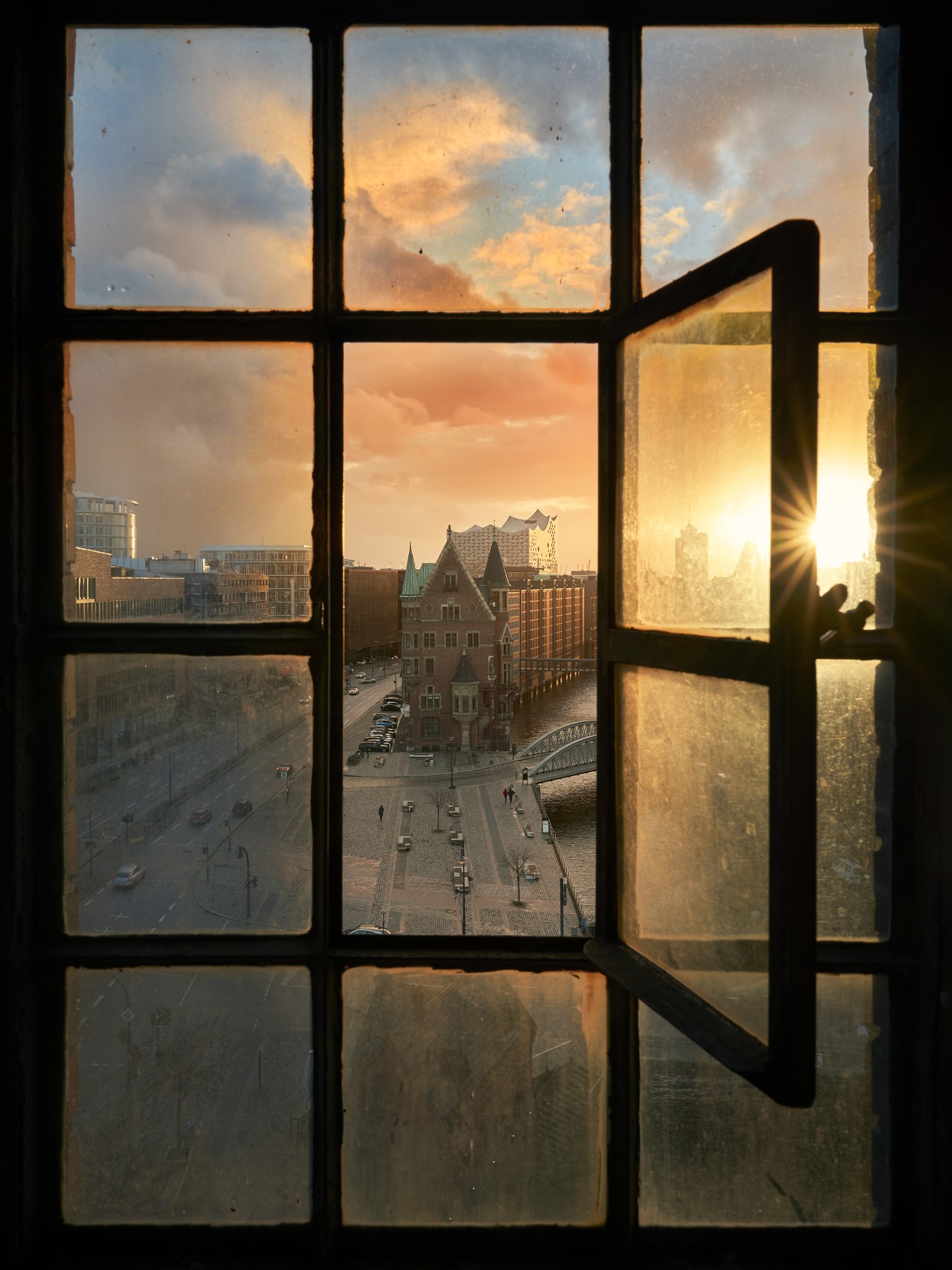 View of Hamburg through a window at sunset HD Phone Wallpaper