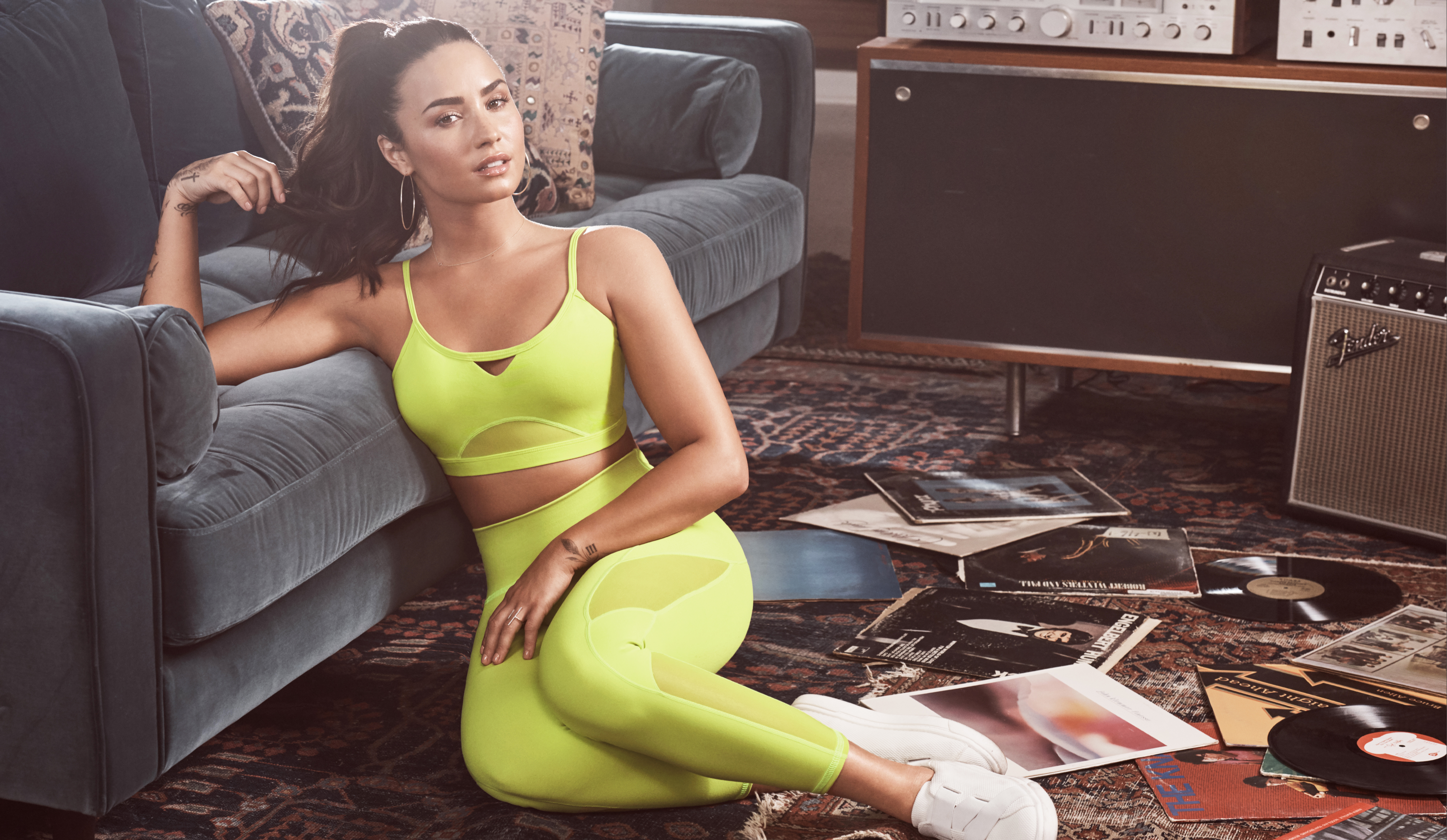 Demi Lovato in neon yellow athletic wear HD Wallpaper