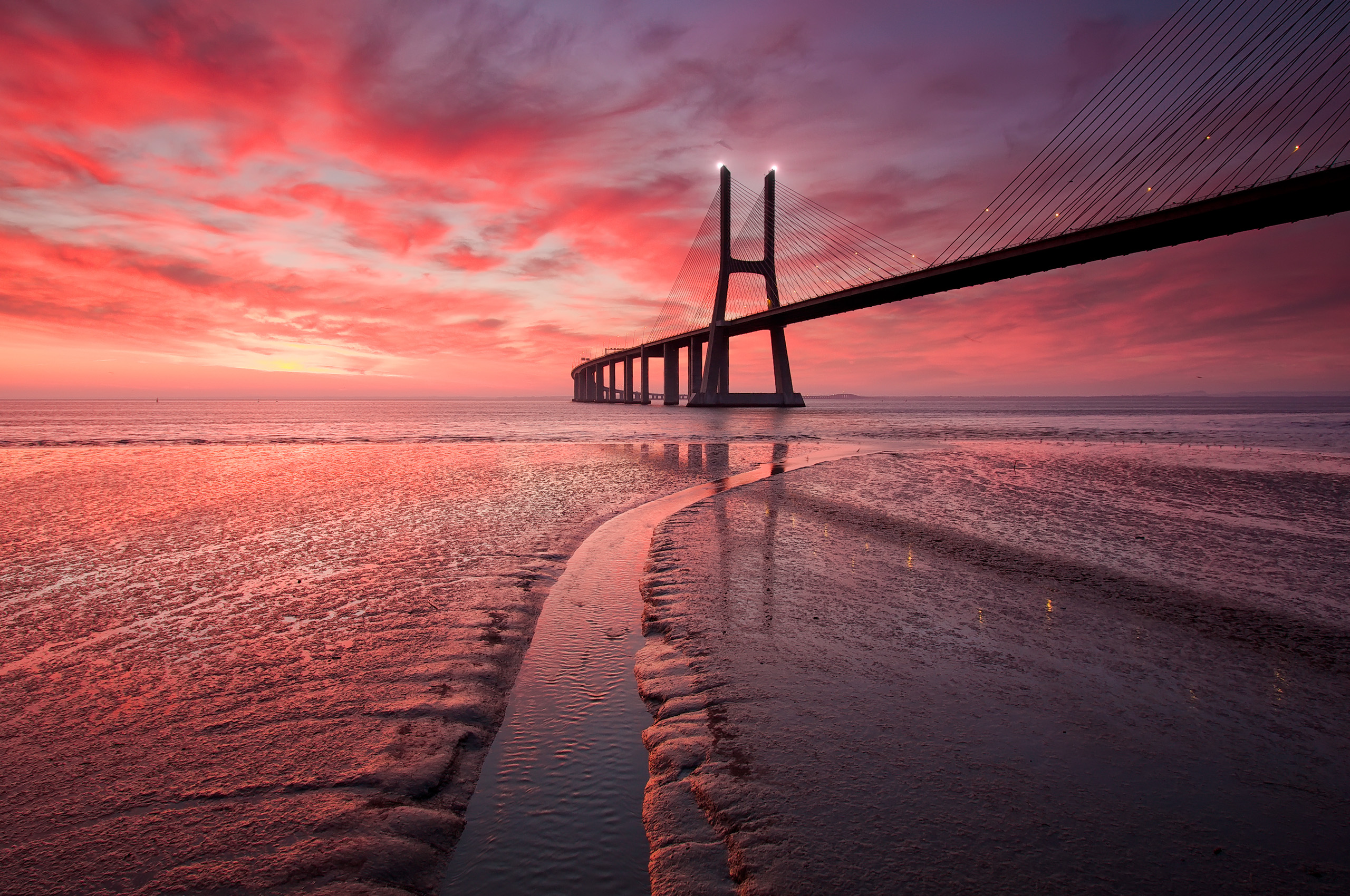 Vasco da Gama Bridge at sunset over Tagus River, Portugal HD Wallpaper