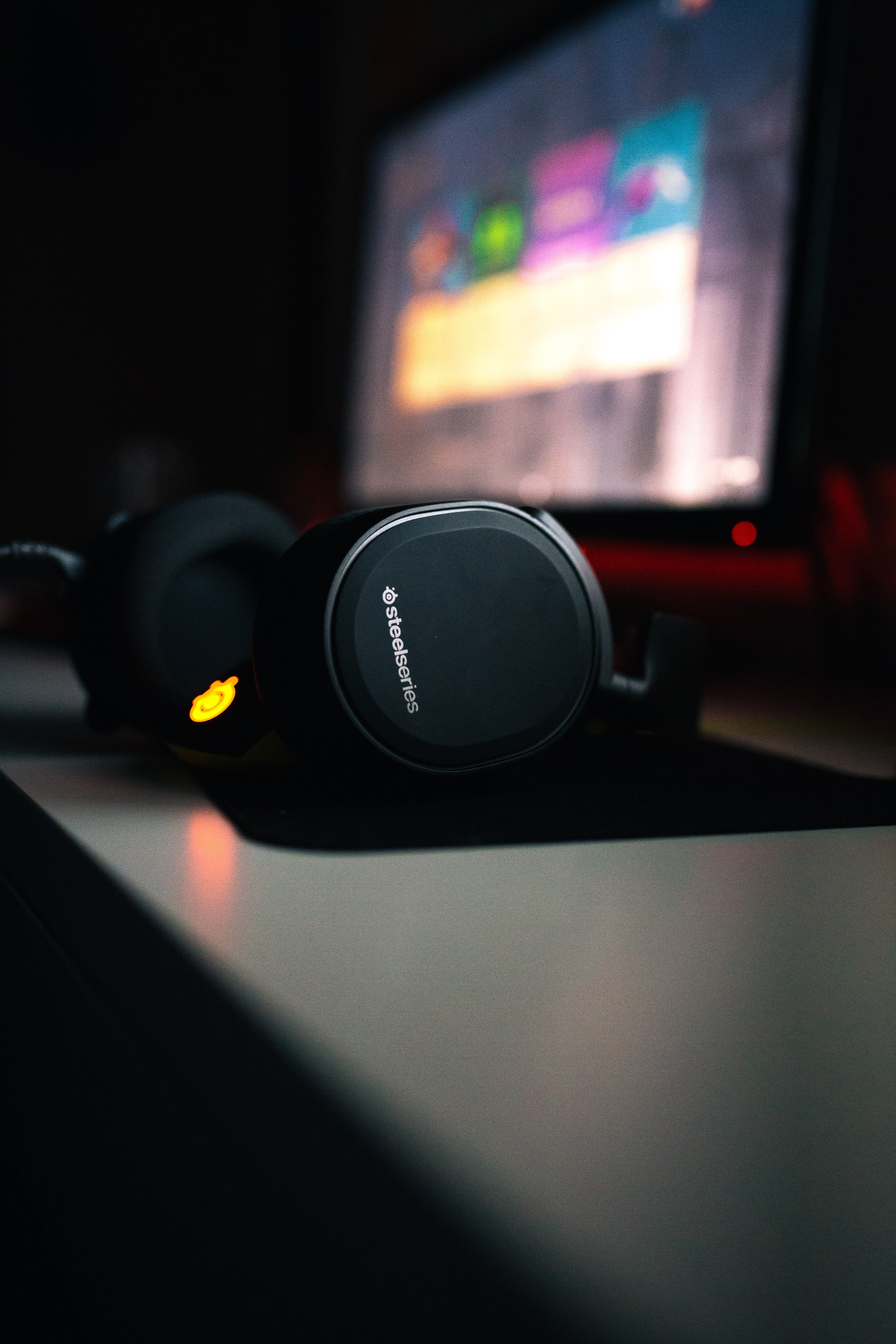 SteelSeries headphones in front of a computer screen HD Phone Wallpaper
