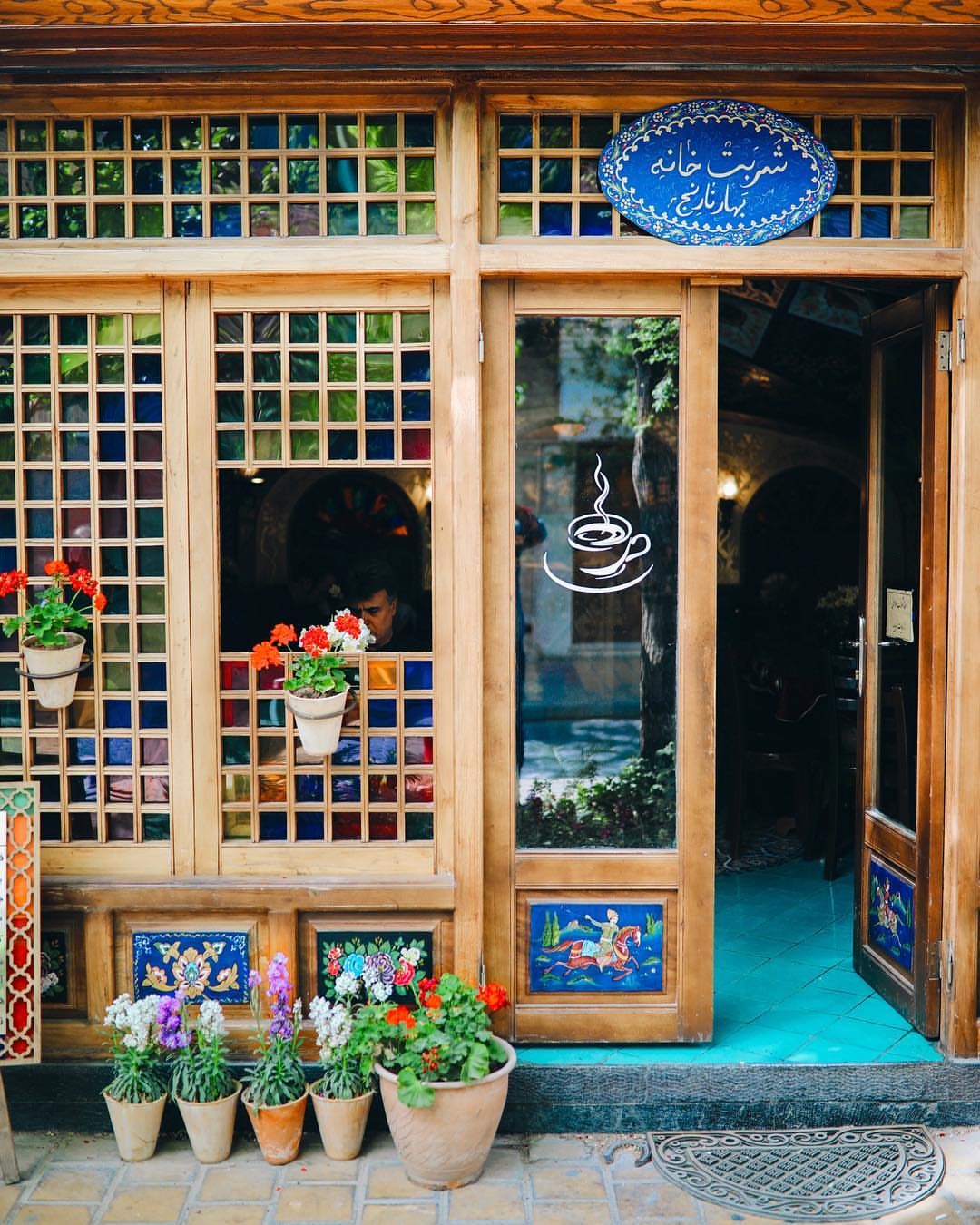 Facade of a cafe in Iran with stained glass and flowers HD Phone Wallpaper