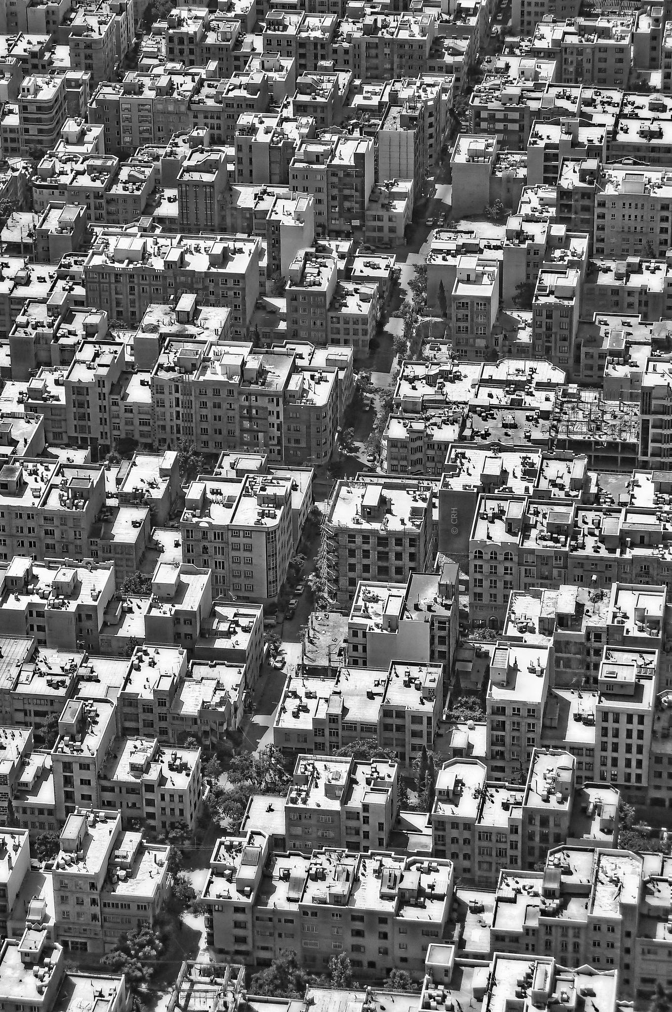 Aerial view of a dense cityscape in monochrome HD Phone Wallpaper