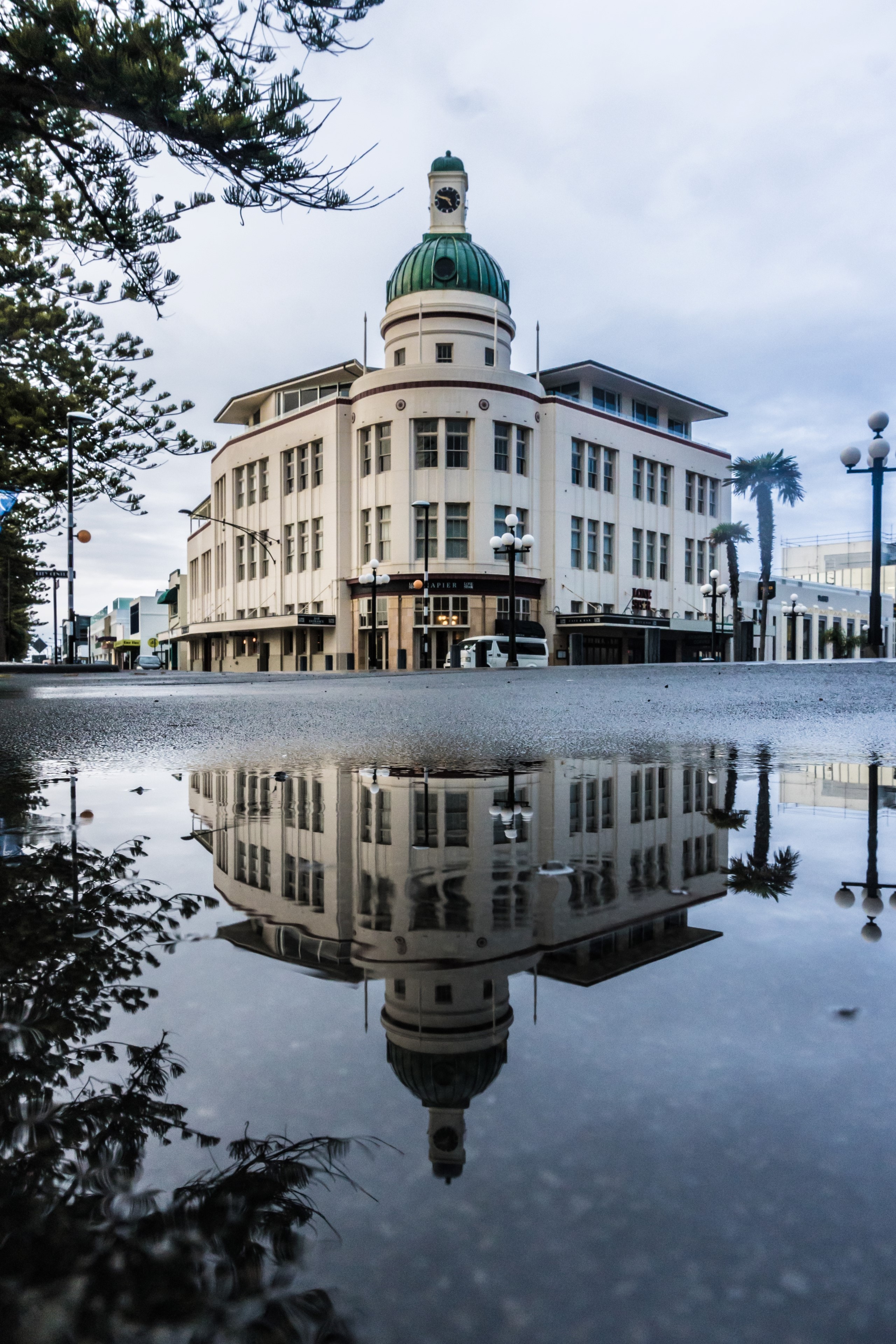 Building with dome reflected in puddle HD Phone Wallpaper