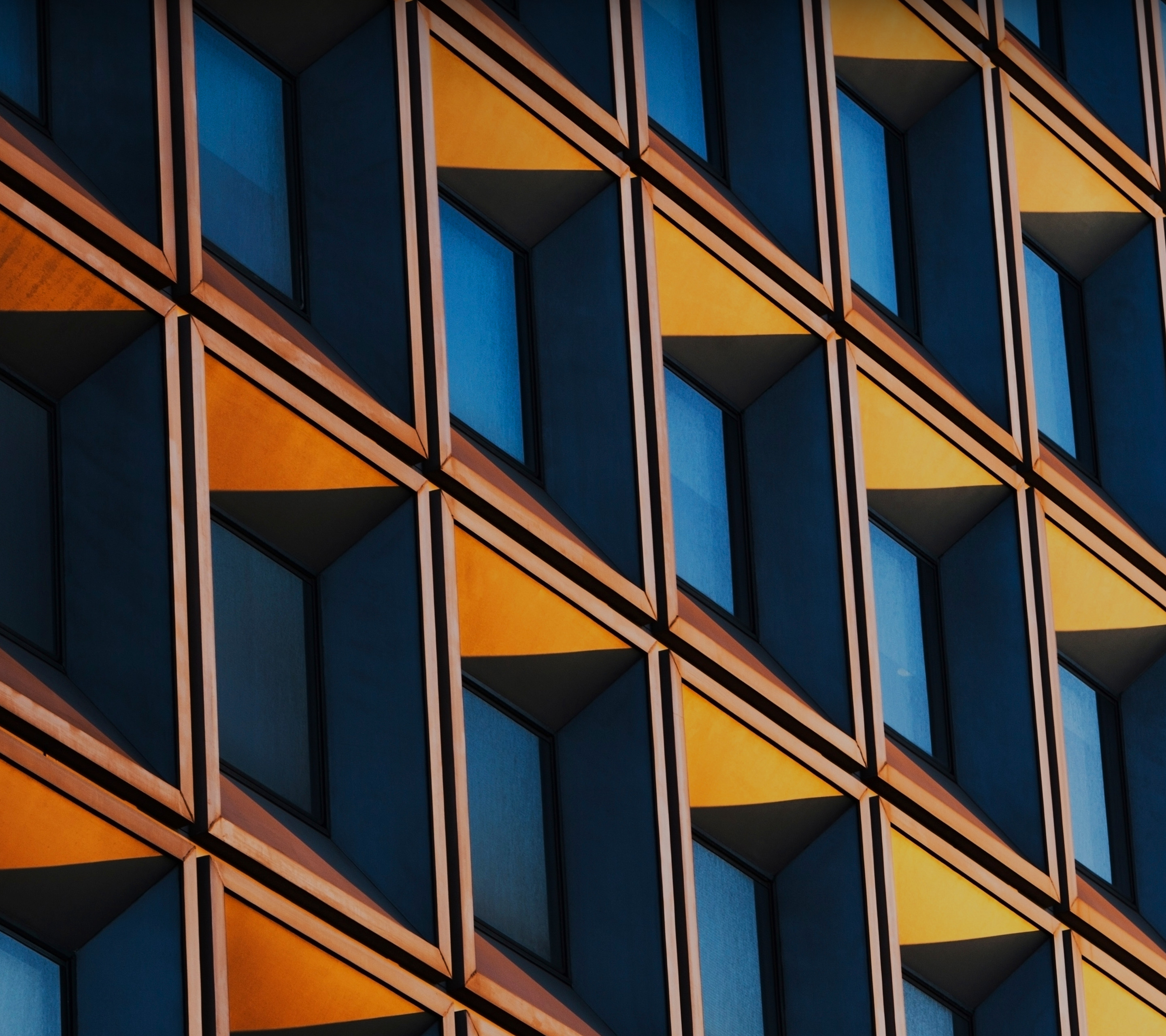Modern building facade with geometric windows HD Wallpaper