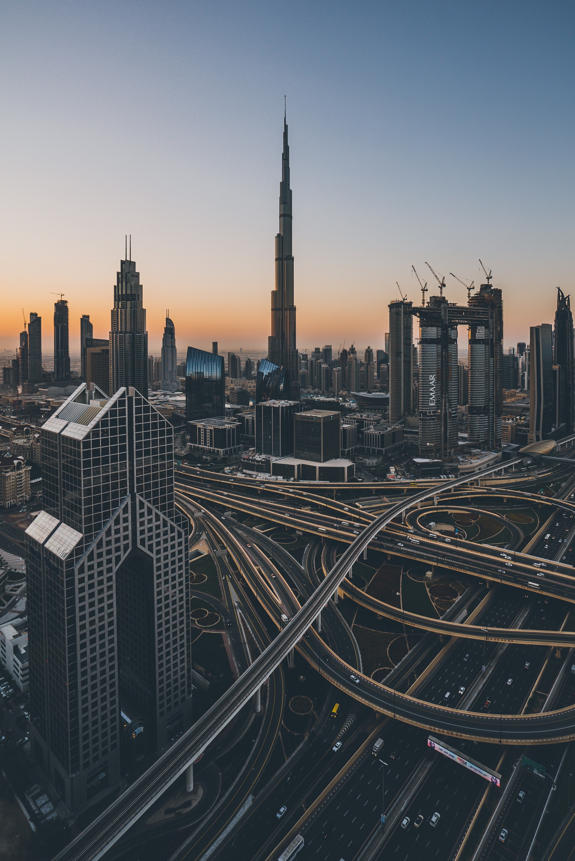 Dubai cityscape with Burj Khalifa and highway interchange HD Phone Wallpaper