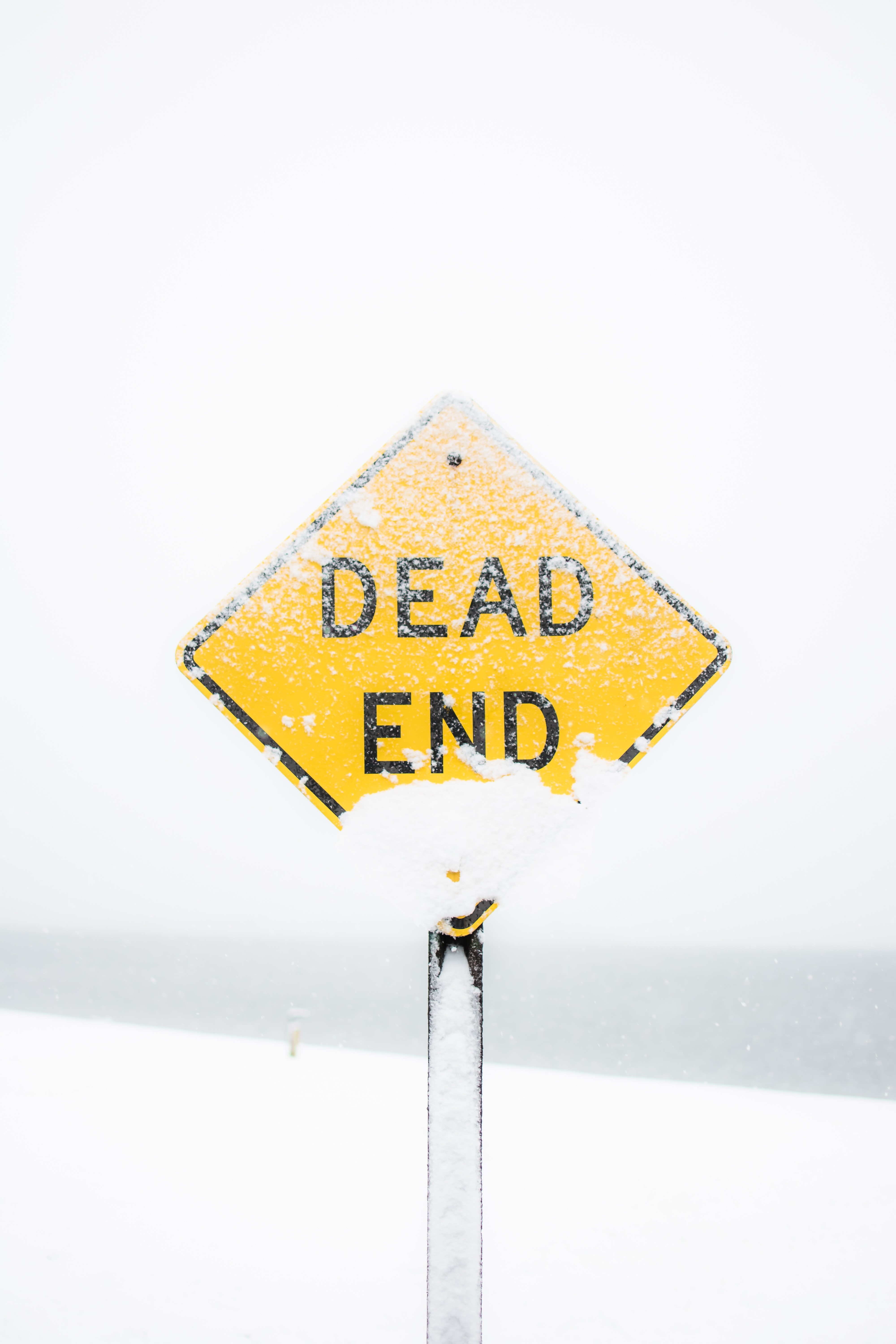 Yellow dead end road sign covered in snow HD Phone Wallpaper