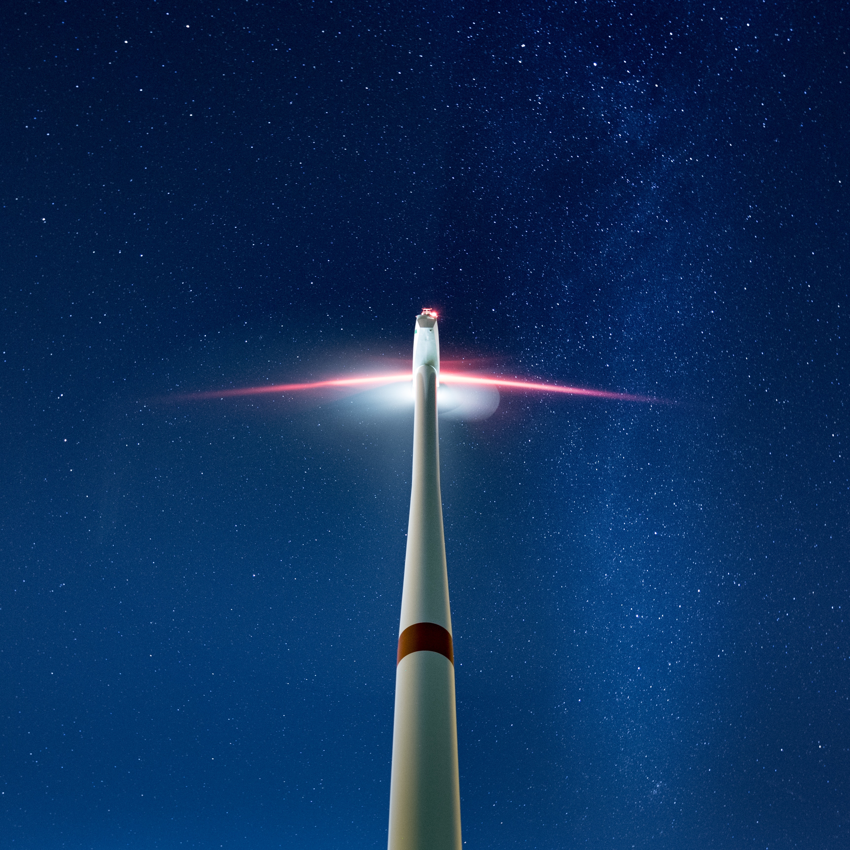 Wind turbine against a starry night sky HD Wallpaper