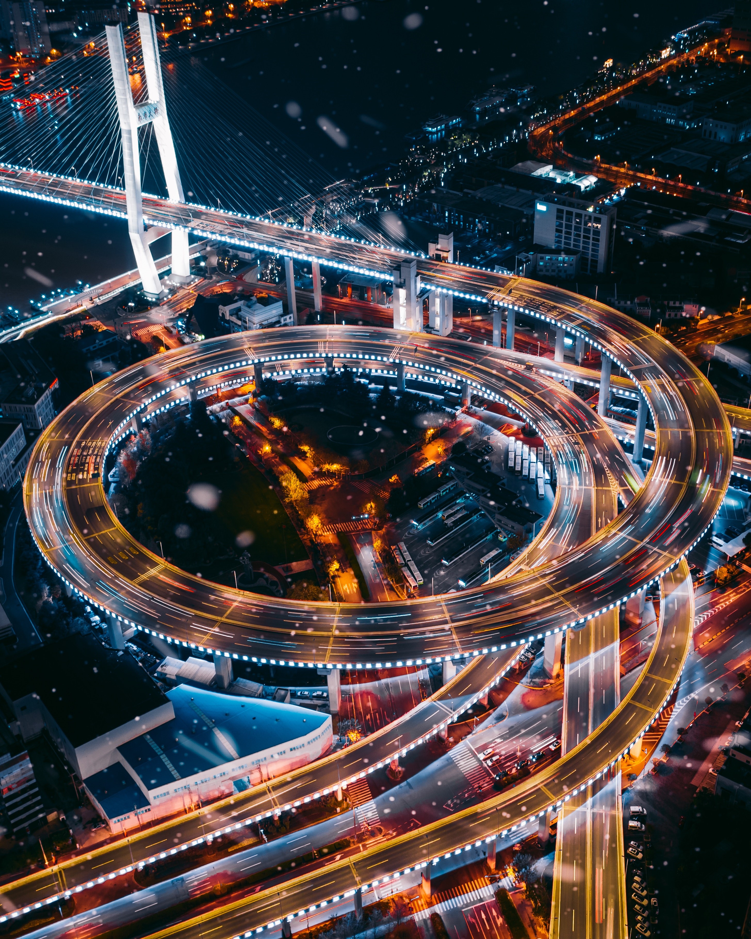 Aerial view of a multi-level highway interchange at night HD Phone Wallpaper