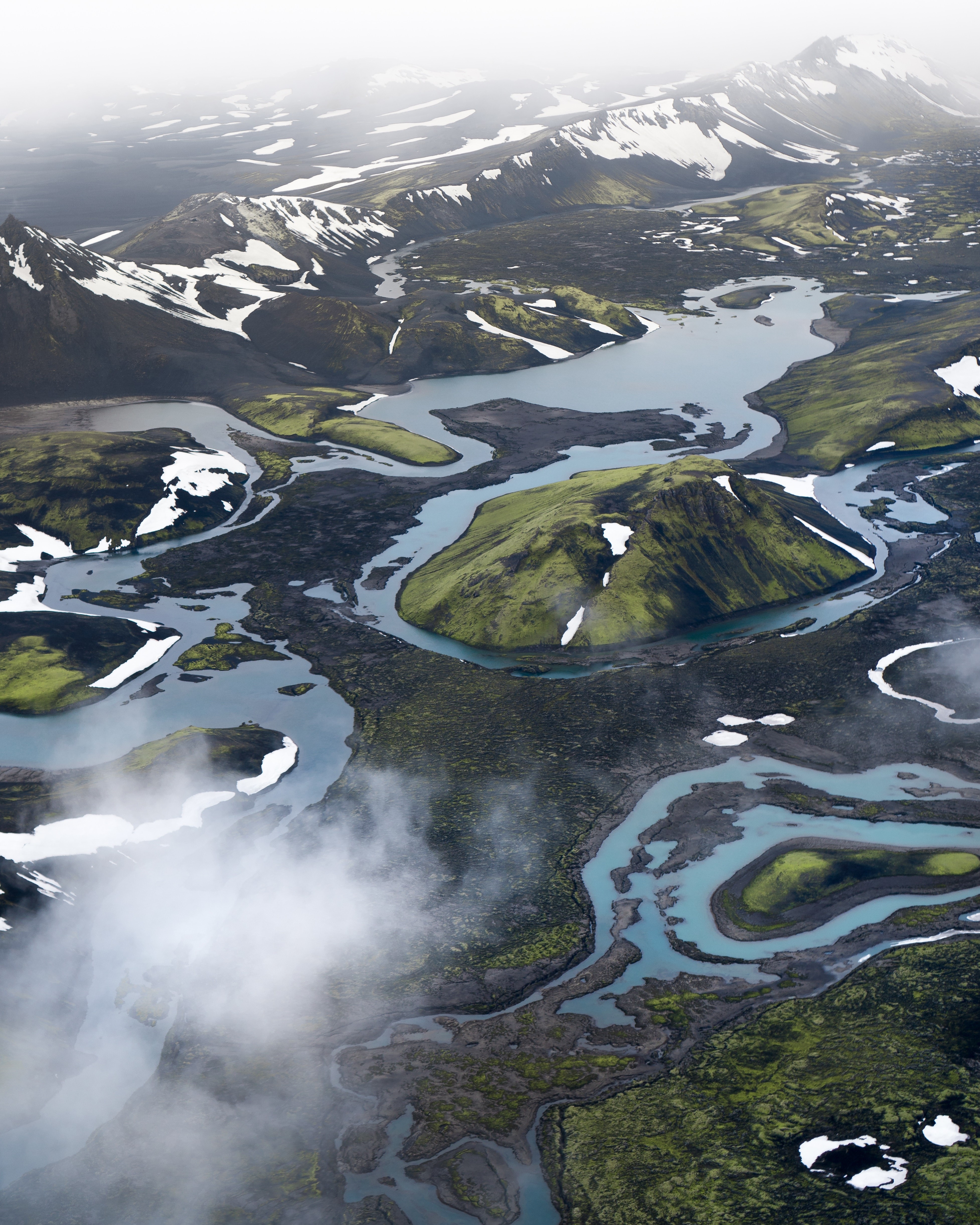 Aerial view of snow-capped mountains and glacial rivers HD Phone Wallpaper