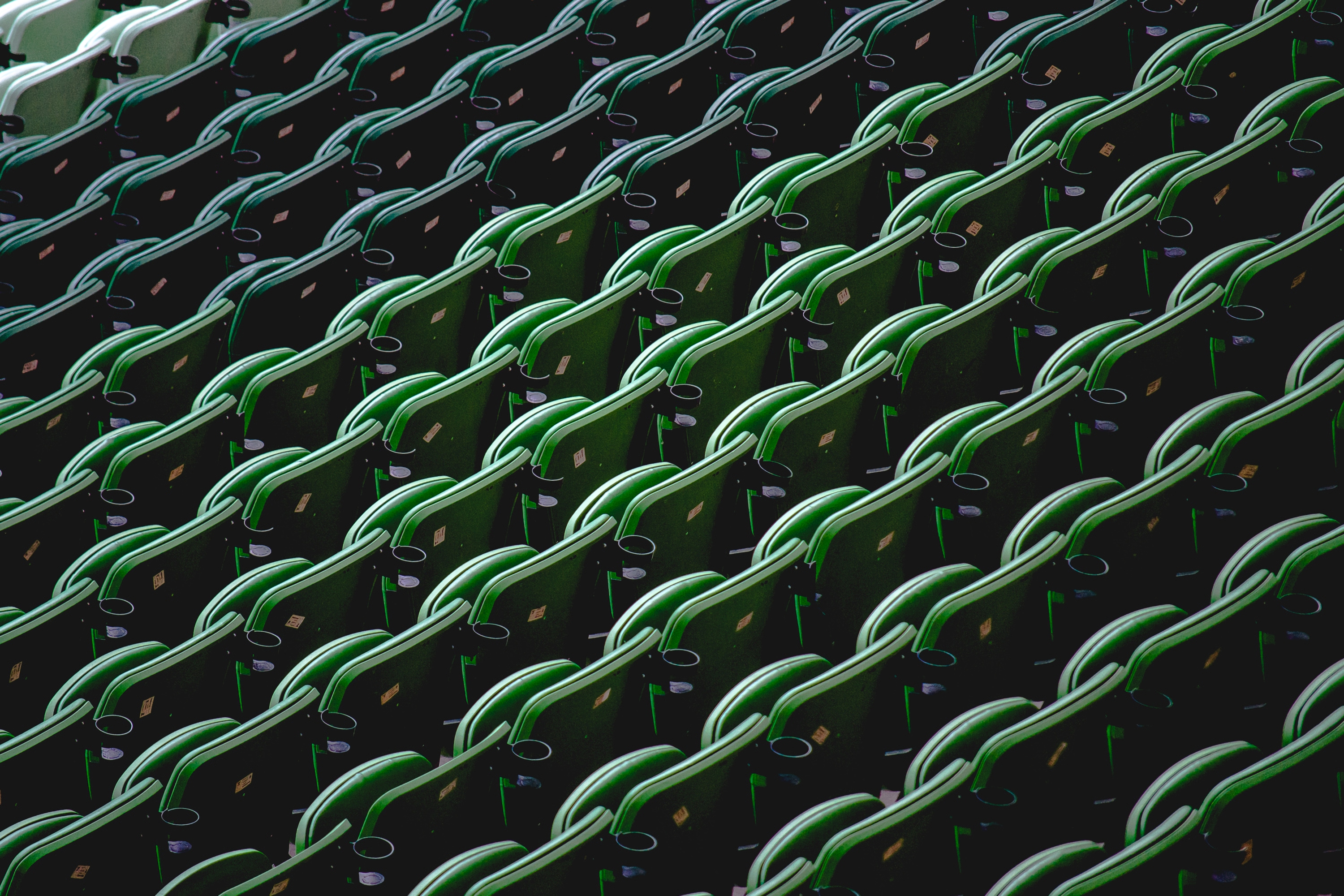 Rows of empty green stadium seats HD Wallpaper