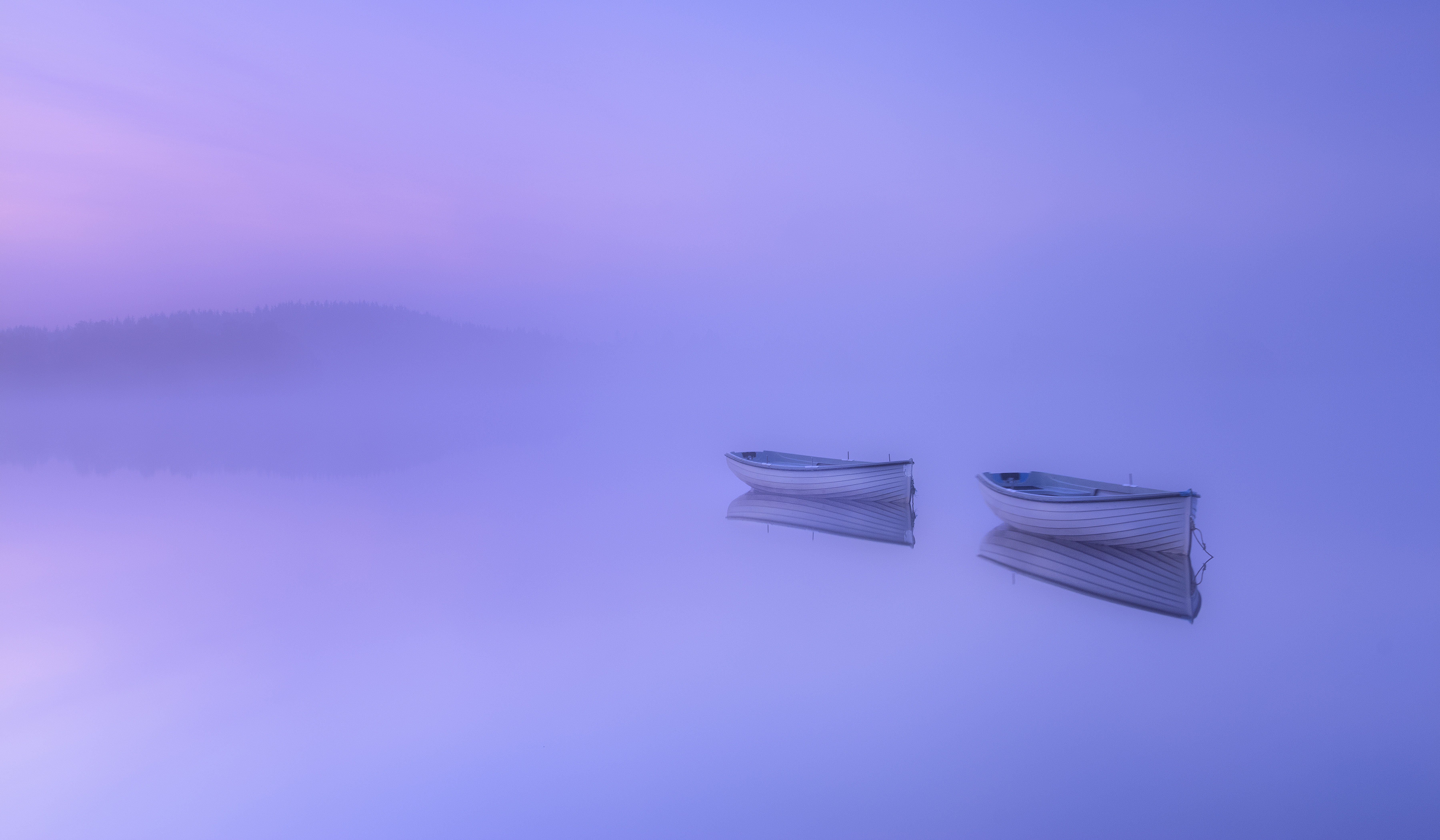 Two rowing boats on a misty lake at sunrise HD Wallpaper