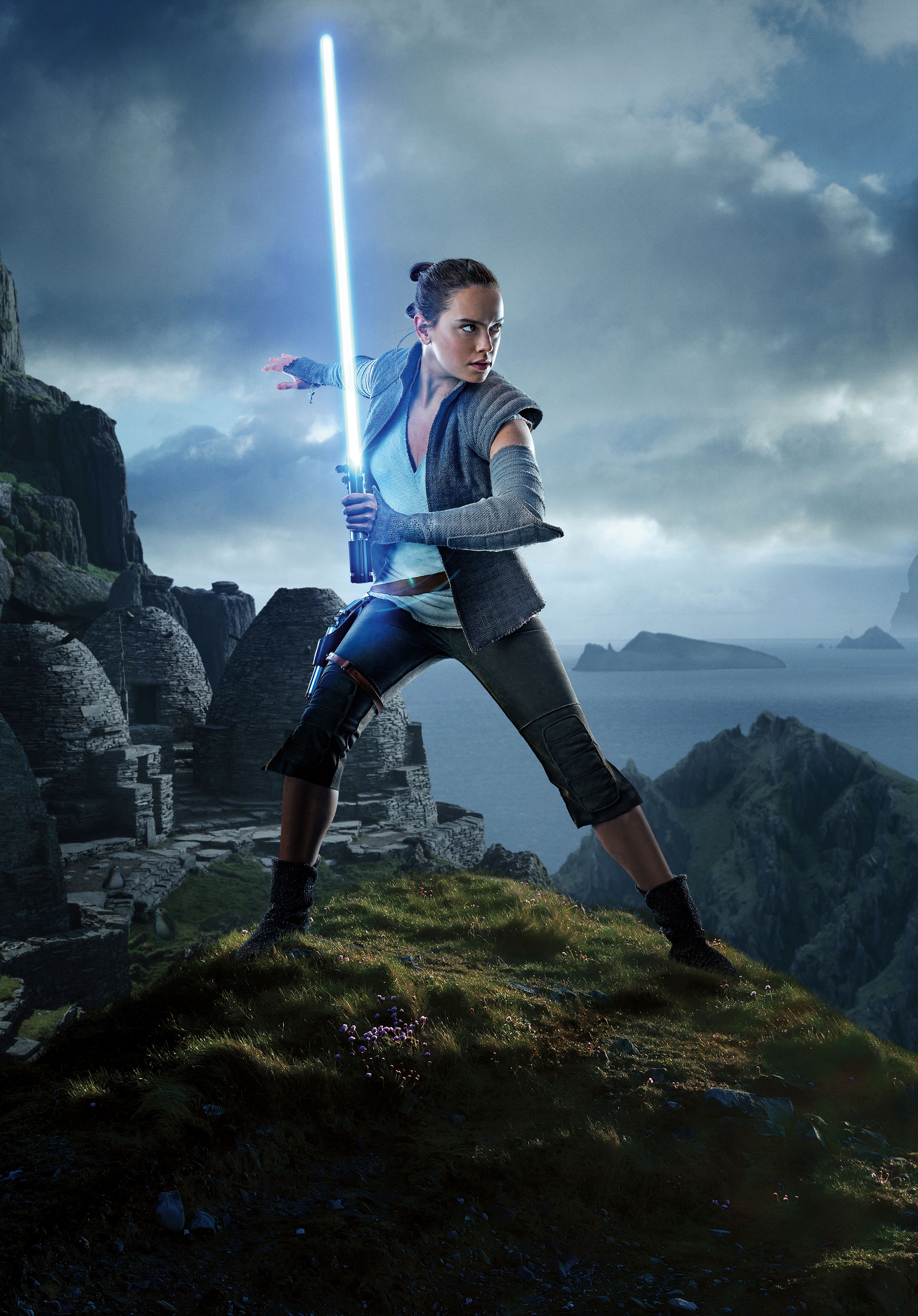 Rey from Star Wars with a lightsaber on a rocky island HD Phone Wallpaper