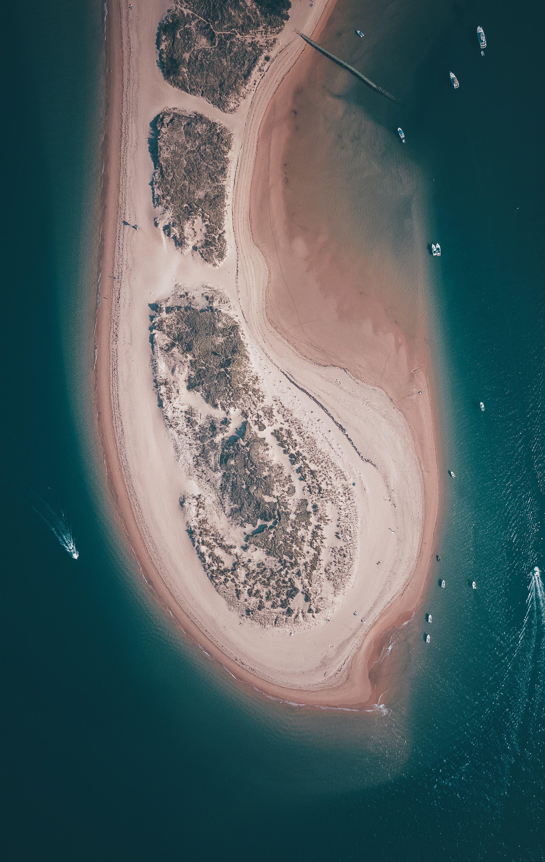 Aerial view of a sandy island with boats in the sea HD Phone Wallpaper
