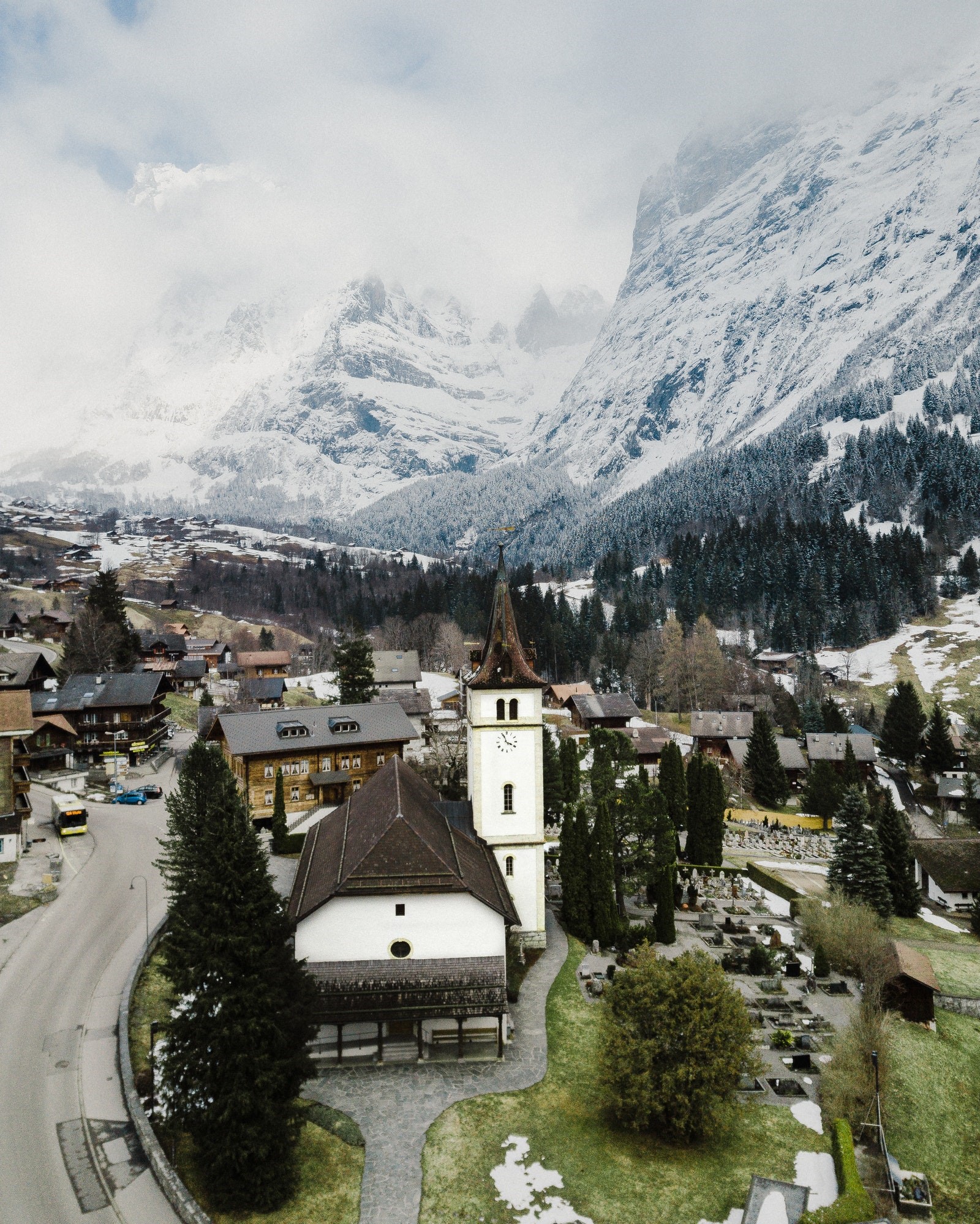 Village church with snow-capped mountains in the background HD Phone Wallpaper