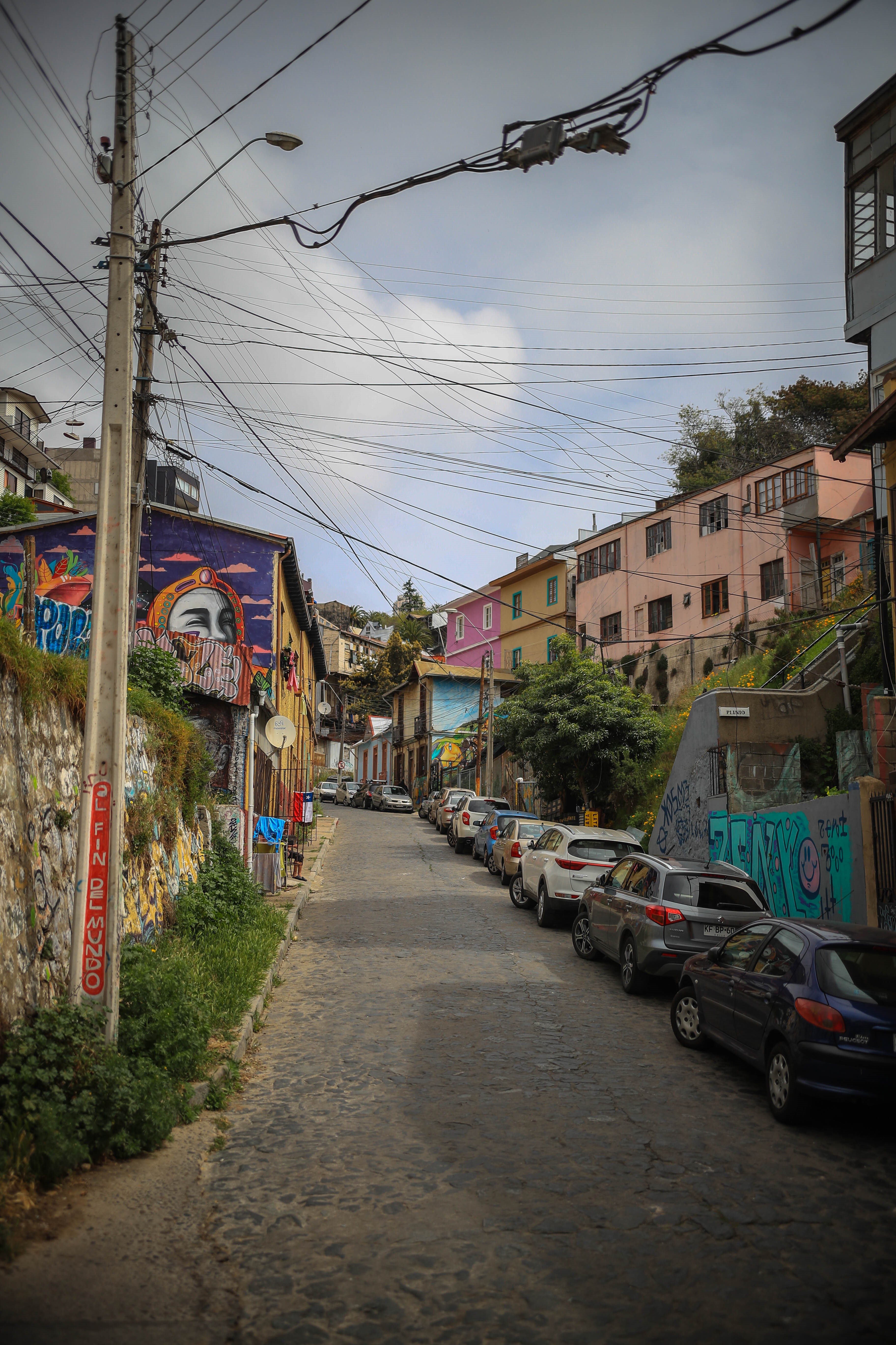Street with parked cars and graffiti in a city HD Phone Wallpaper