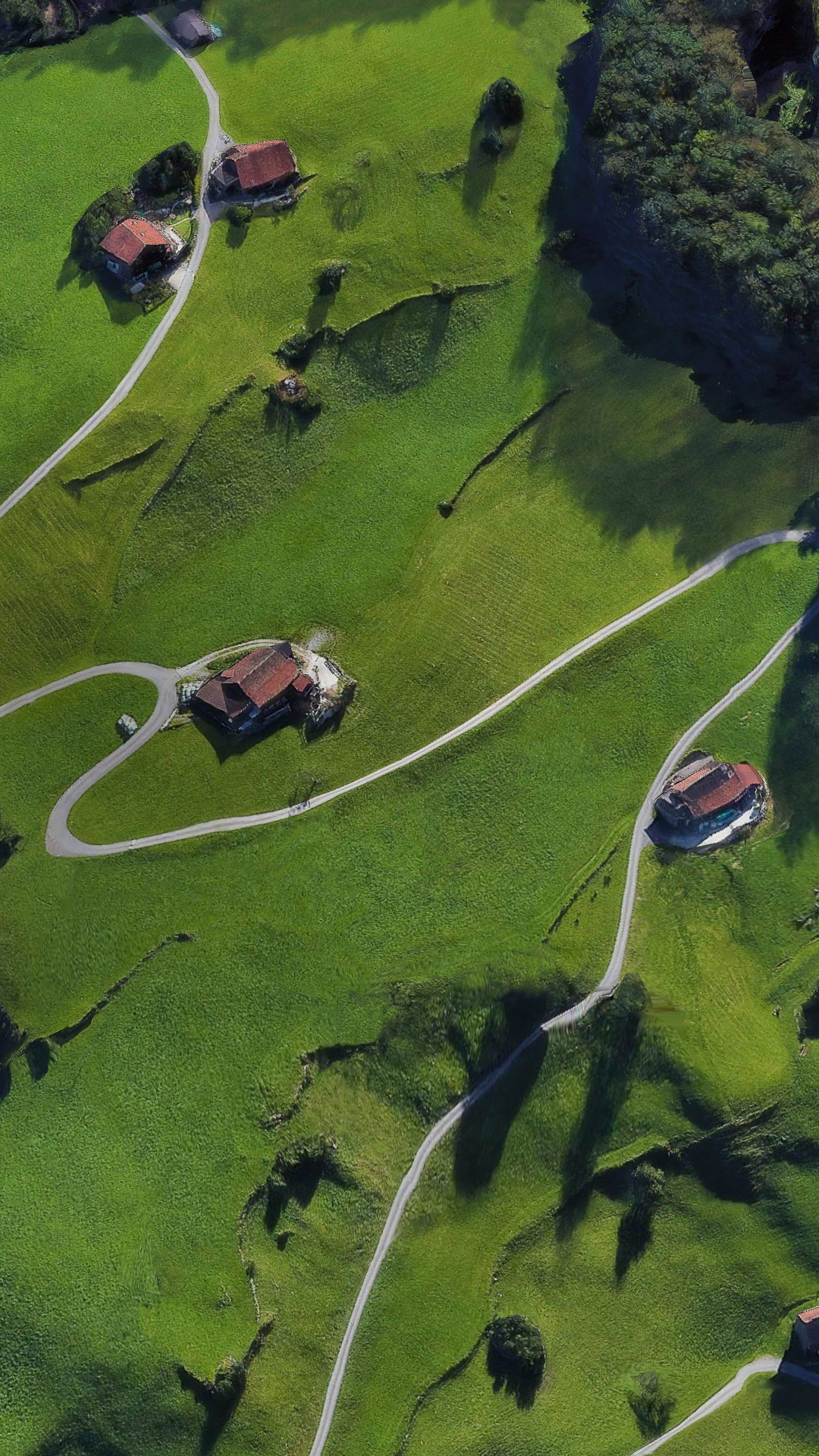 Aerial view of a rural village with winding roads HD Phone Wallpaper
