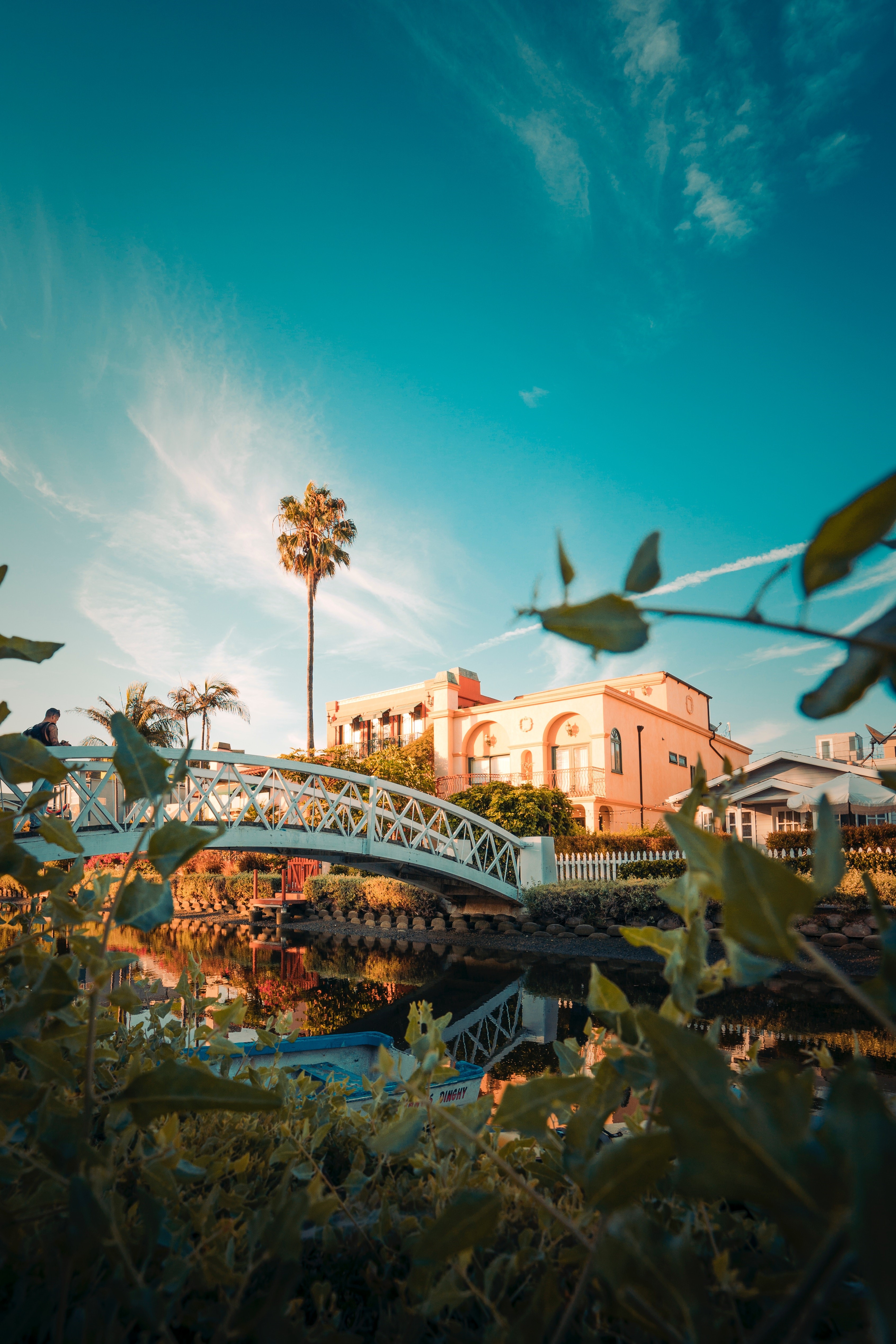 White bridge over canal with palm trees and buildings HD Phone Wallpaper