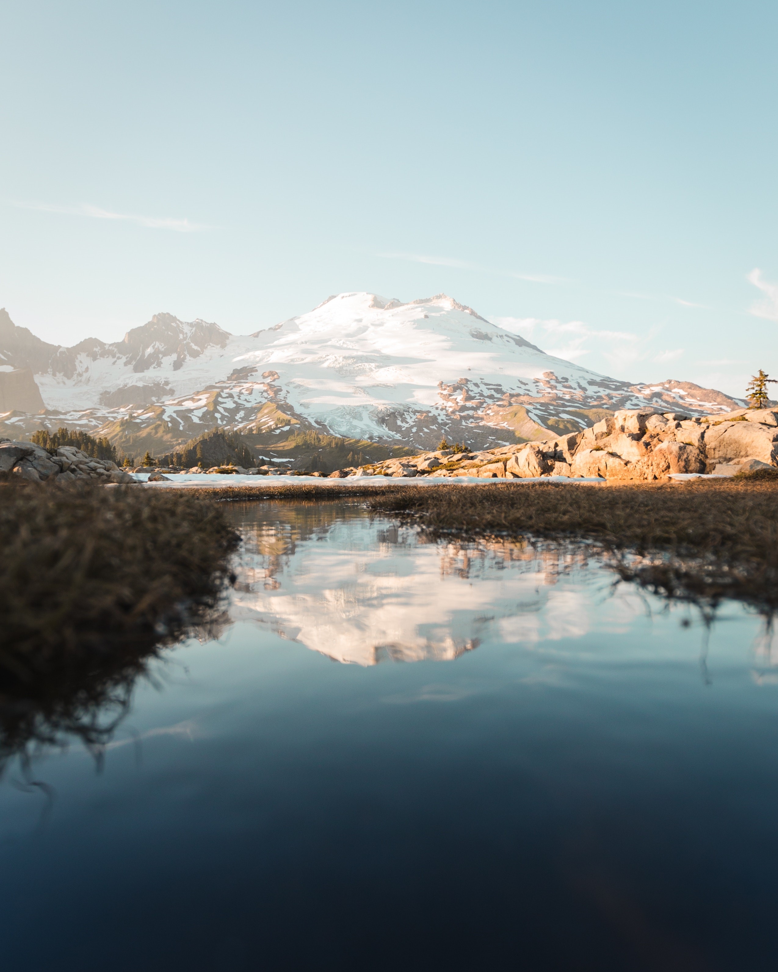 Snow-capped mountains reflected in a calm lake HD Phone Wallpaper