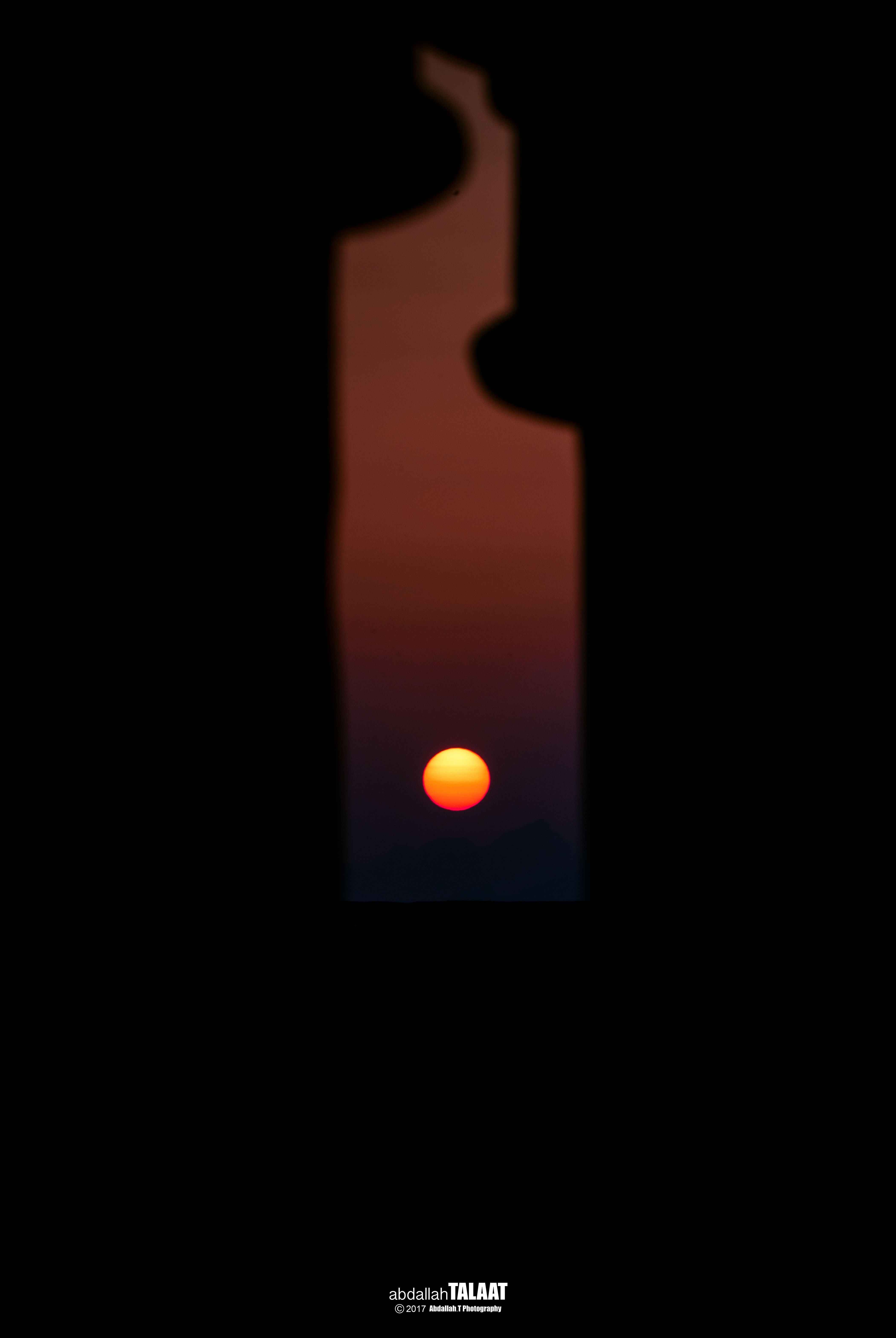 Sunset viewed through a silhouette HD Phone Wallpaper